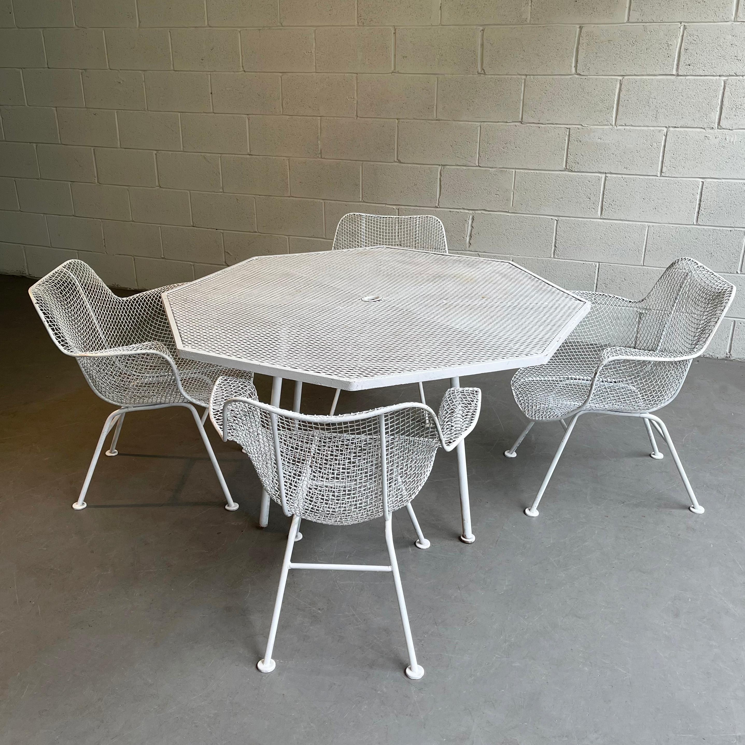 Mid-Century Modern, steel mesh and wrought iron, outdoor, patio dining set by Russell Woodard, Sculptura features 4 armchairs with a 52 inch diameter octagonal dining table. The chairs measure 26 W x 25 D x 27 Ht, seat Ht 13.