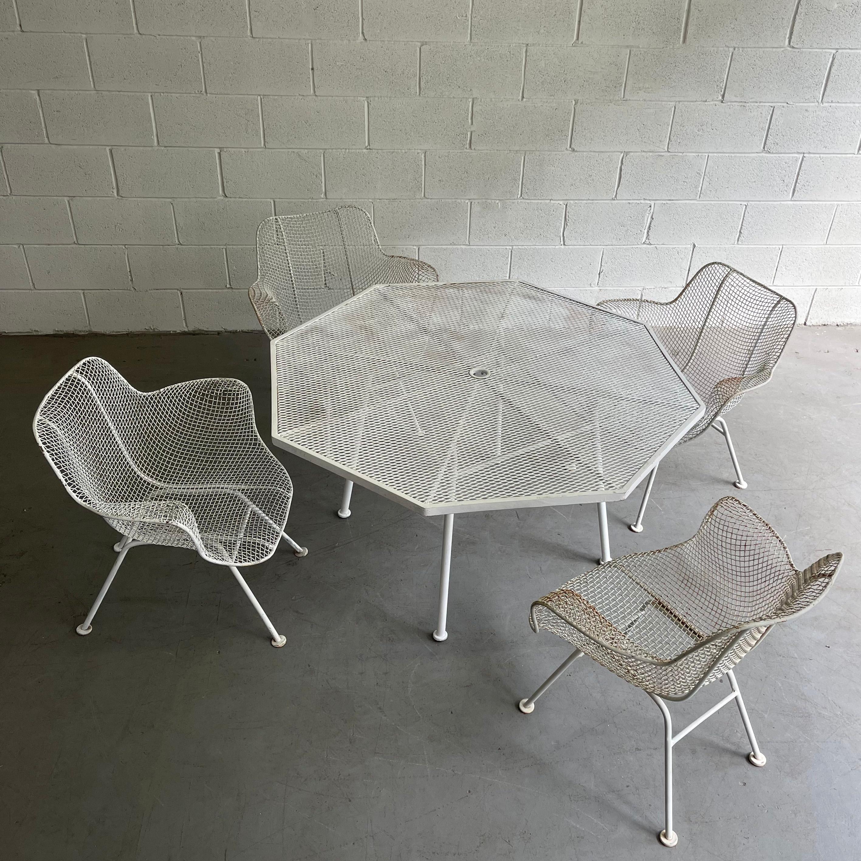Mid-Century Modern, steel mesh and wrought iron, outdoor, patio dining set by Russell Woodard, Sculptura features 4 armchairs with a 52 inch diameter octagonal dining table. The chairs measure 26 W x 25 D x 27 Ht, seat Height 13.