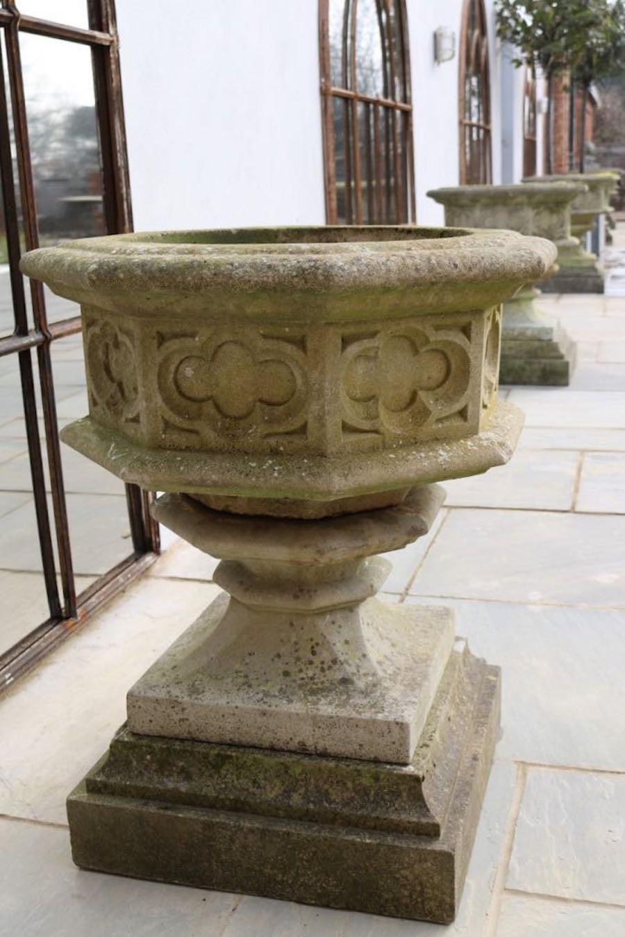 1920's English pair of octagonal shaped stone garden urns on stepped base.
Decorative gothic motif.
Stone is embedded with spores and lichen create natural patina.
ARRIVING TBD.