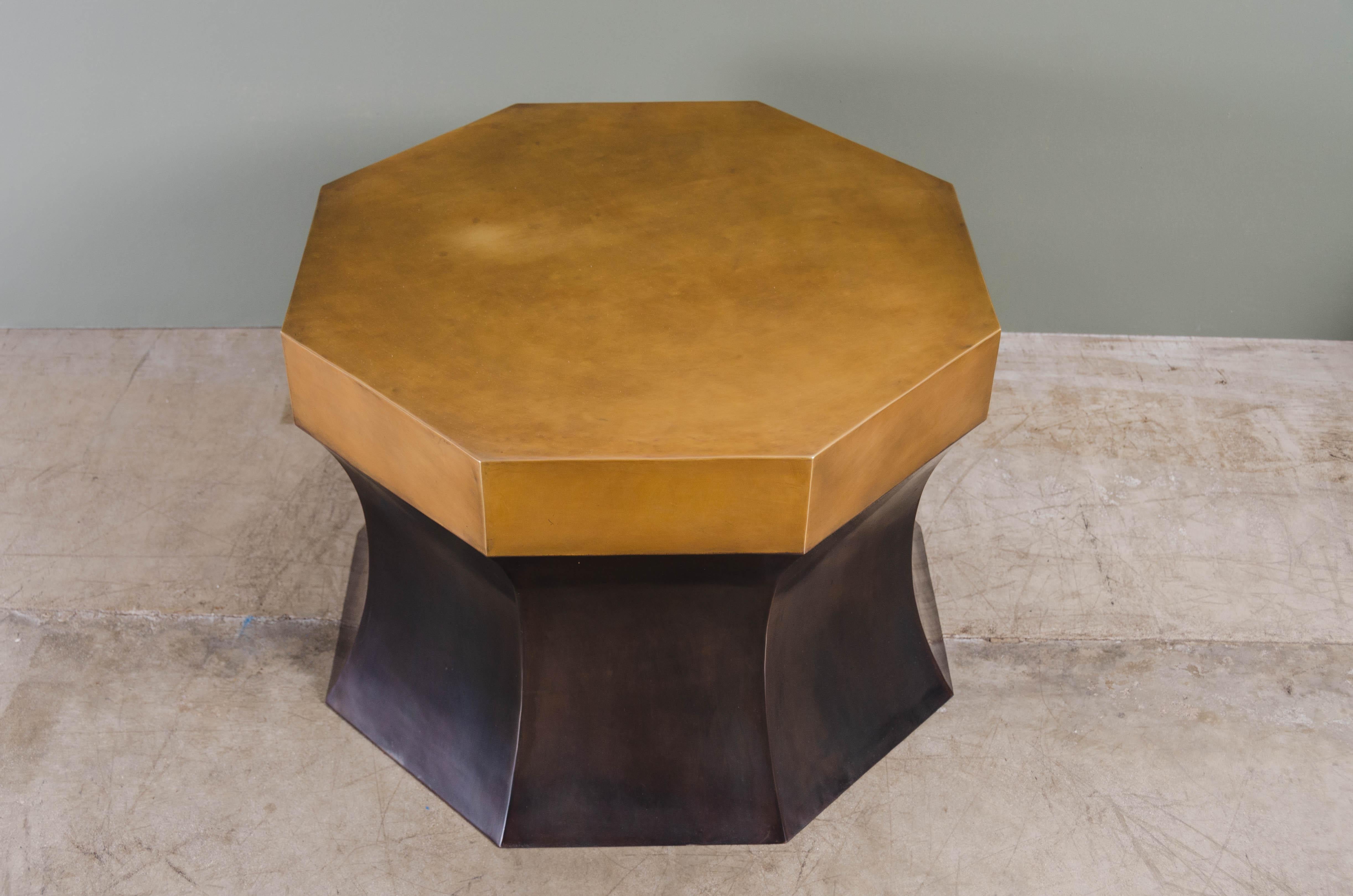 Octagonal side table with brass
Antique copper
Brass
Hand repoussé
Limited Edition

Repoussé is the traditional art of hand-hammering decorative relief onto sheet metal. The technique originated circa 800 BC between Asia and Europe and in