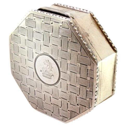 Octagonal silver box w/ reliefs surrounding the monogram card on the hinged lid