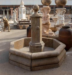 Octagonal Stone Garden Fountain with a Central Column and a Spherical Finial