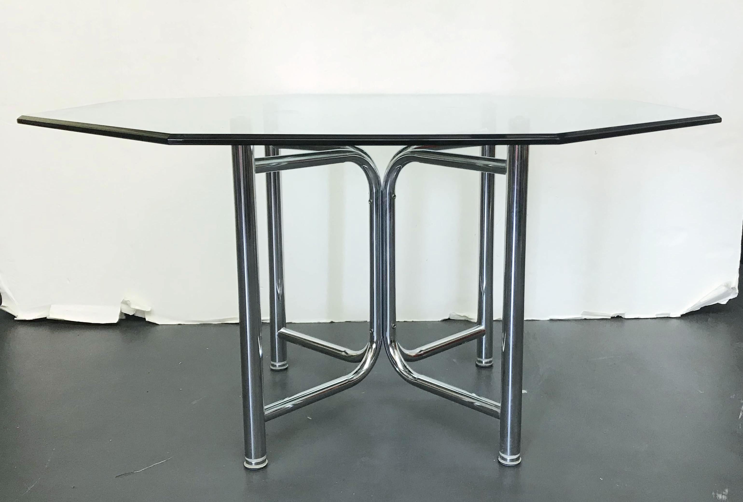 Vintage dining table with curved tubular chrome base supporting a thick octagonal beveled glass top / made in the USA, circa 1970s.
Measures: Diameter 58 inches, height 29 inches
1 available in stock in Palm Springs ON FINAL CLEARANCE SALE for