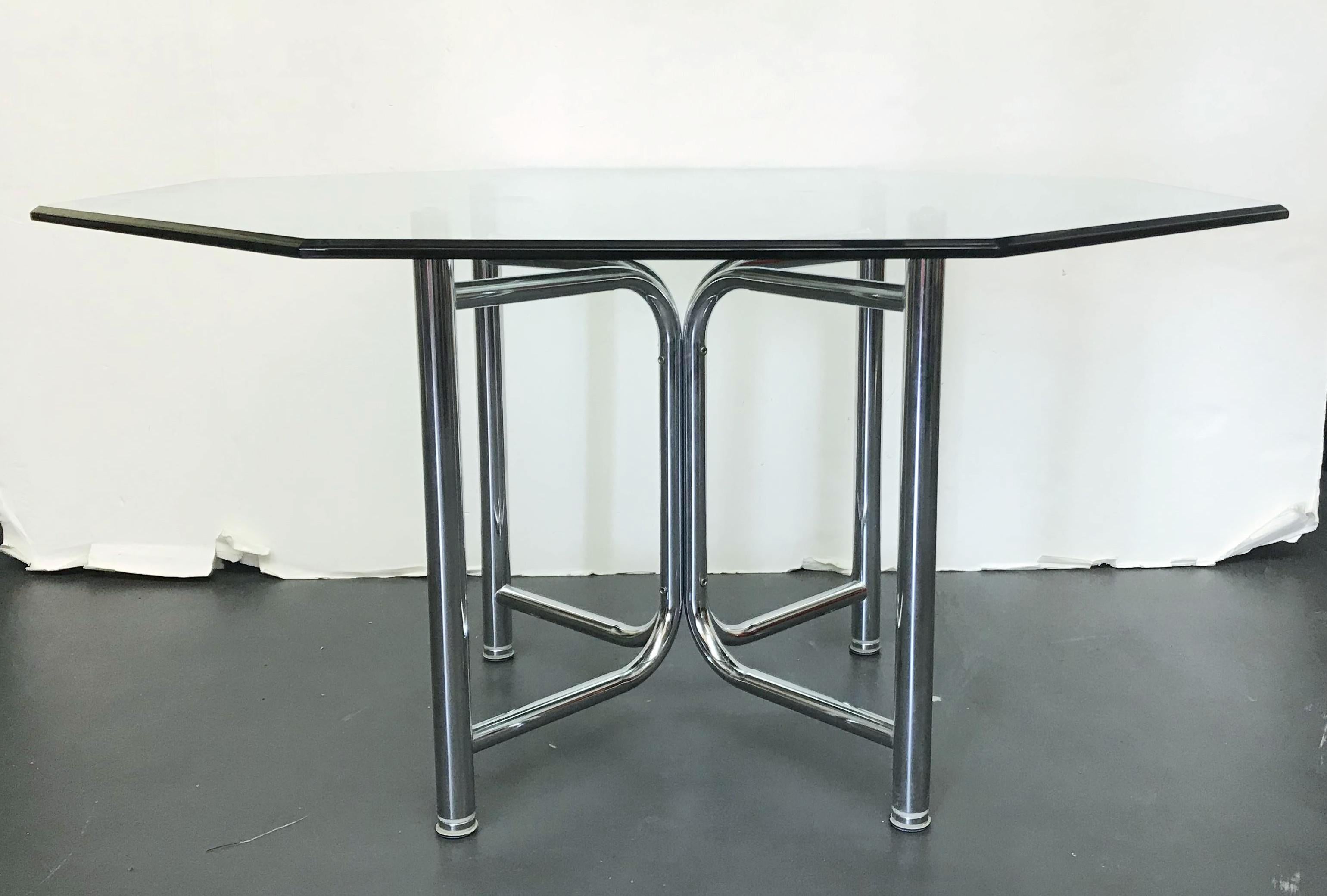 Vintage dining table with curved tubular chrome base supporting a thick octagonal beveled glass top / Made in the USA, circa 1970s.
Measures: diameter 58 inches, height 29 inches
1 available in stock in Palm Springs ON FINAL CLEARANCE SALE for