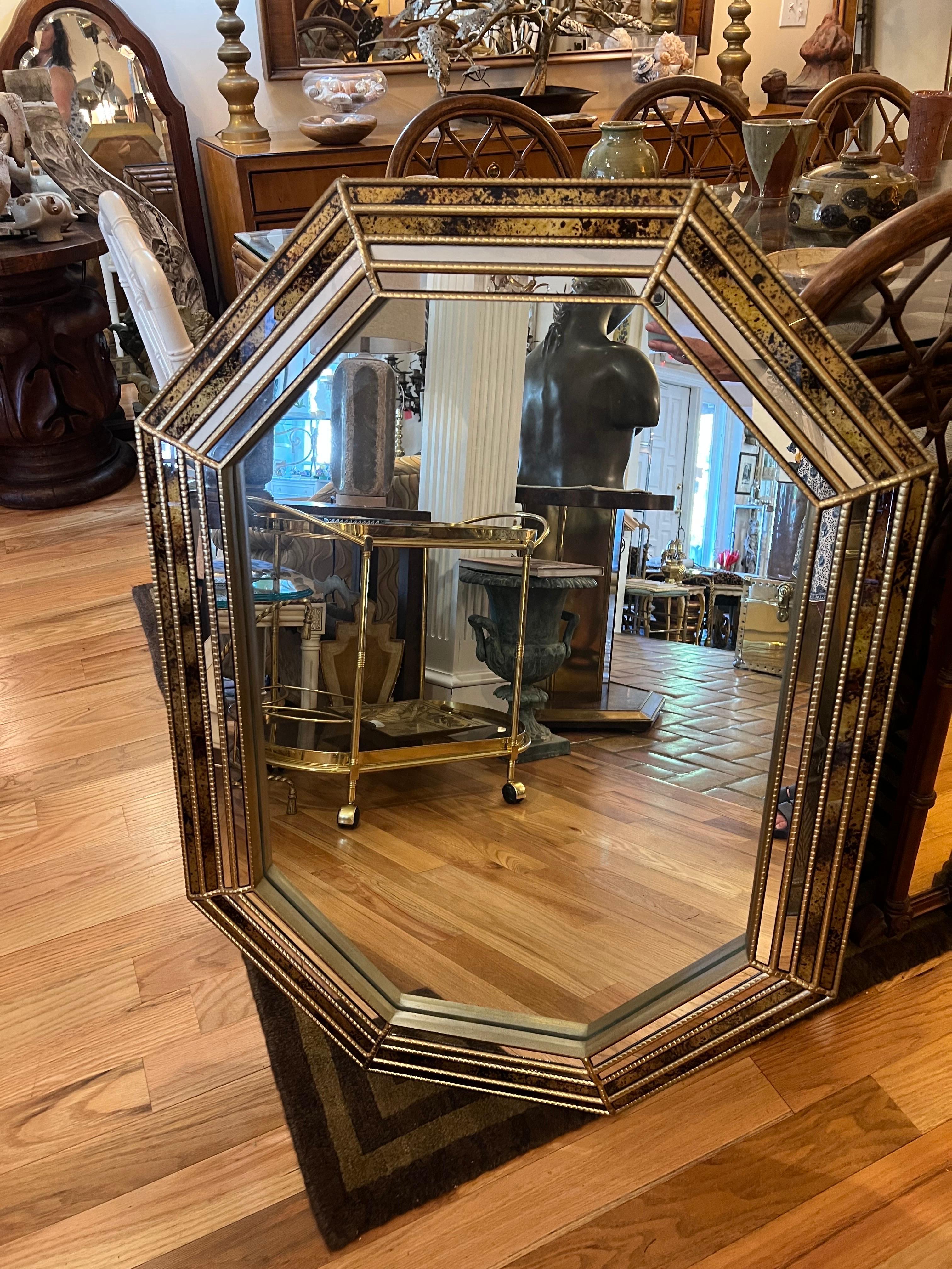 Octagonal Tortoiseshell mirror attributed to LaBarge. Nice beveled mirror with four spiderweb style outer rings with tortoiseshell oil drip panels which give it a nice depth.