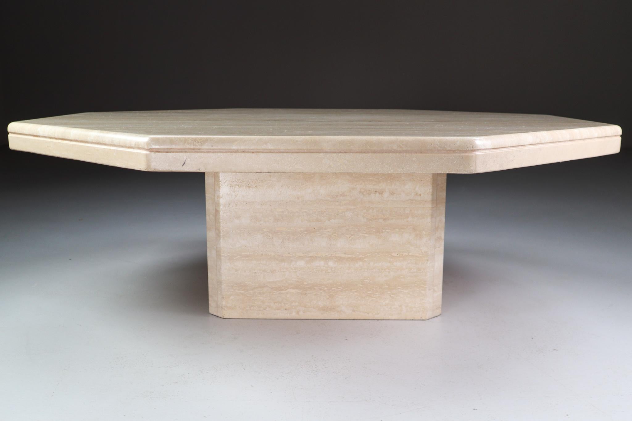 A slab octagonal of thick travertine rests on a wide base in this stylish and simple coffee table. The tabletop is carved with striped rounded edge profile. Stone is a material rich in itself. Echoing classical sculpture, a design that's sleek and