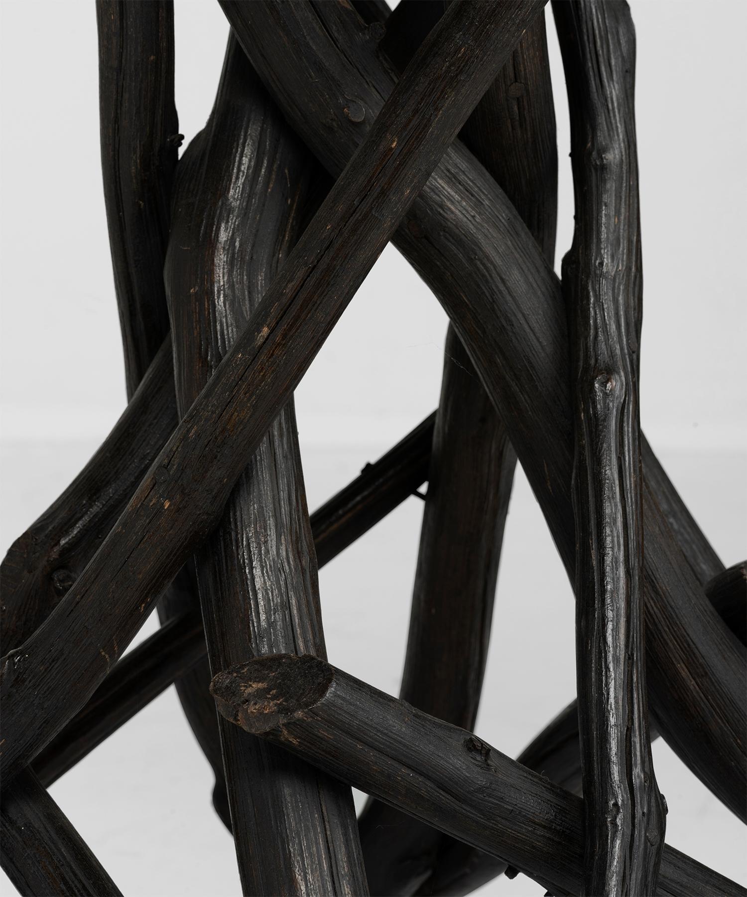 Octagonal planked top on rustic, ebonized twig base.