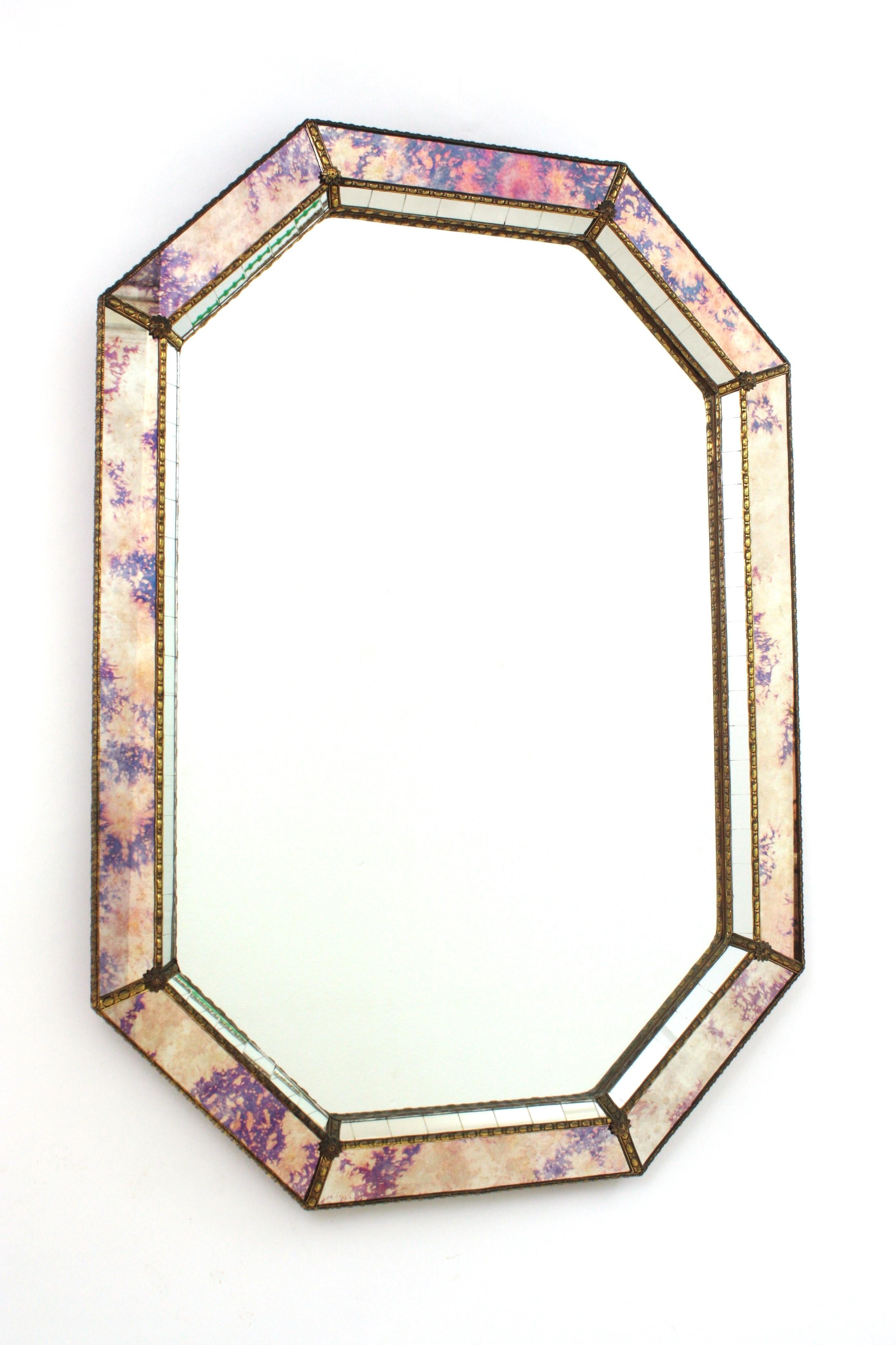 Superbe miroir octogonal de style vénitien Hollywood Regency avec des panneaux en verre irisé et miroir. Espagne, années 1960
Ce miroir mural glamour présente un cadre à double couche en laiton. Forme et cadre octogonaux avec deux couches de miroirs