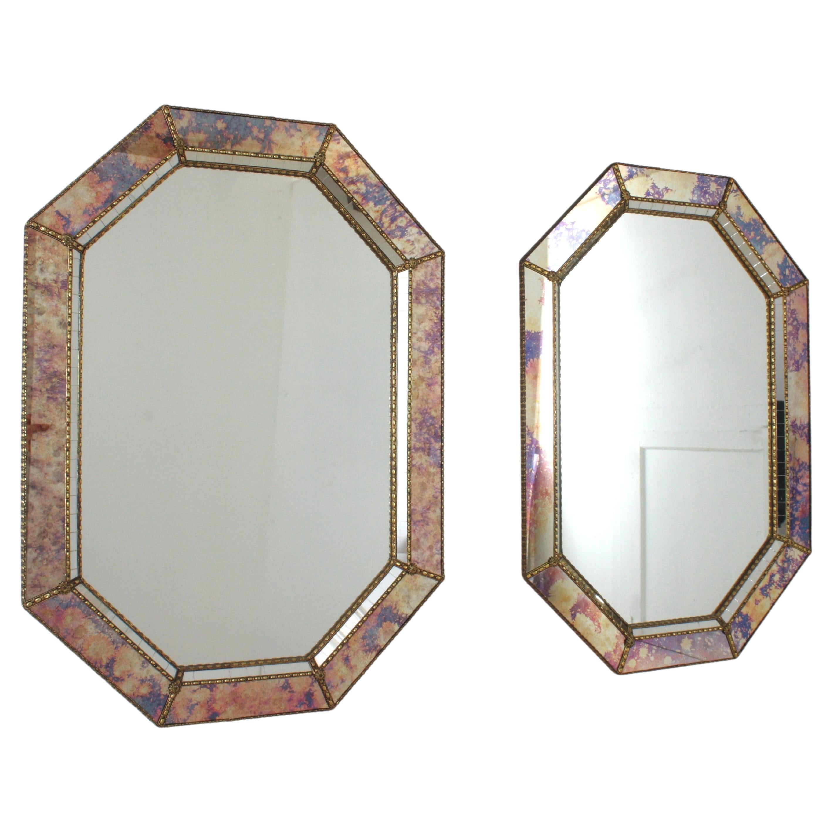 Cool Venetian style Hollywood Regency octagonal mirrors with iridiscent and mirror glass panels. Spain, 1960s
This glamorous pair of wall mirrors feature double layered mirror frames made of brass. Octagonal form with frames with two layers of