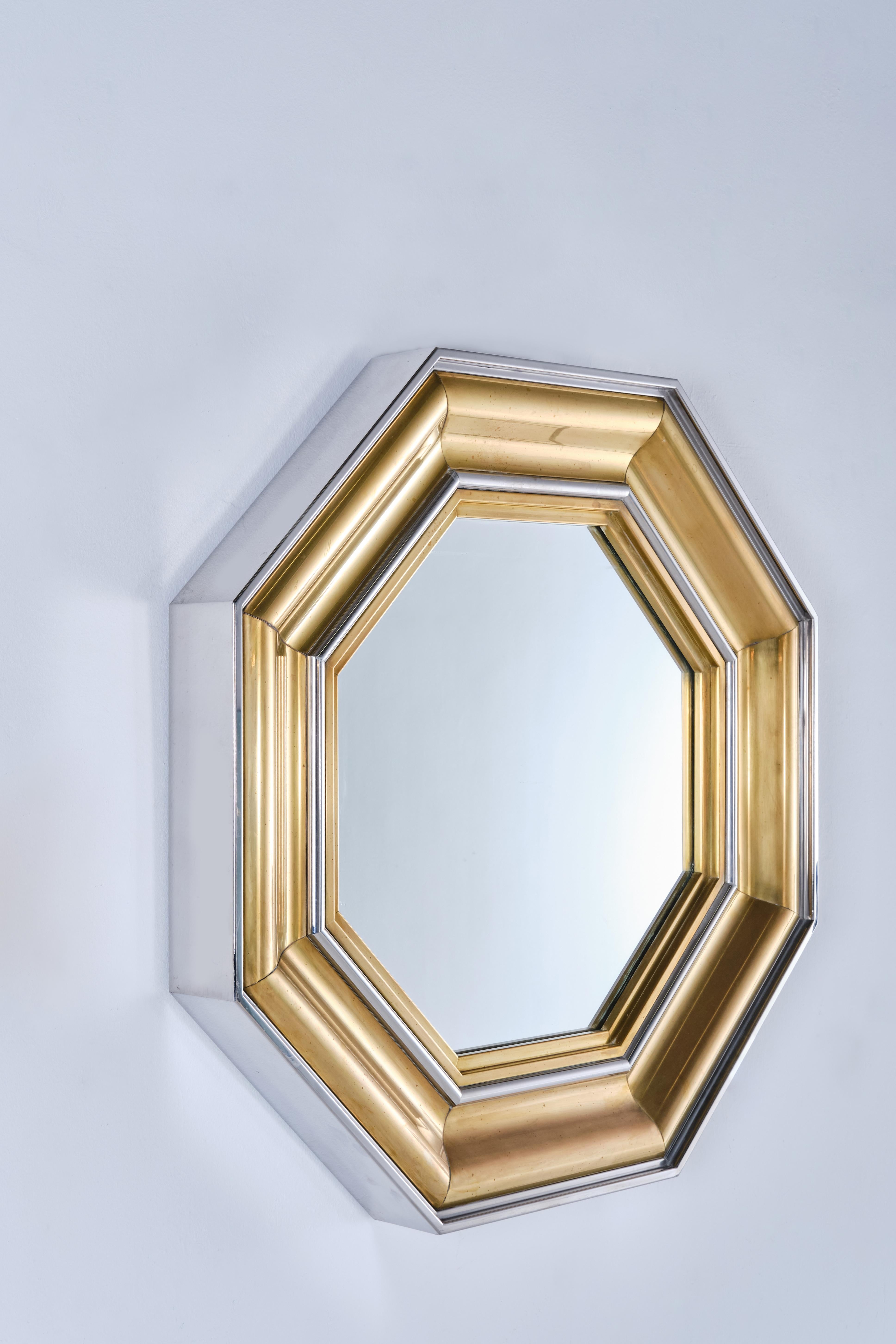 This wall mounted octagonal mirror was designed by Sandro Petti for Maison Jansen. Qintessentially 70s taste, this stylish mirror is a piece of fine craftsmanship for alternating stepped layers of brass and chrome and will make the difference in any