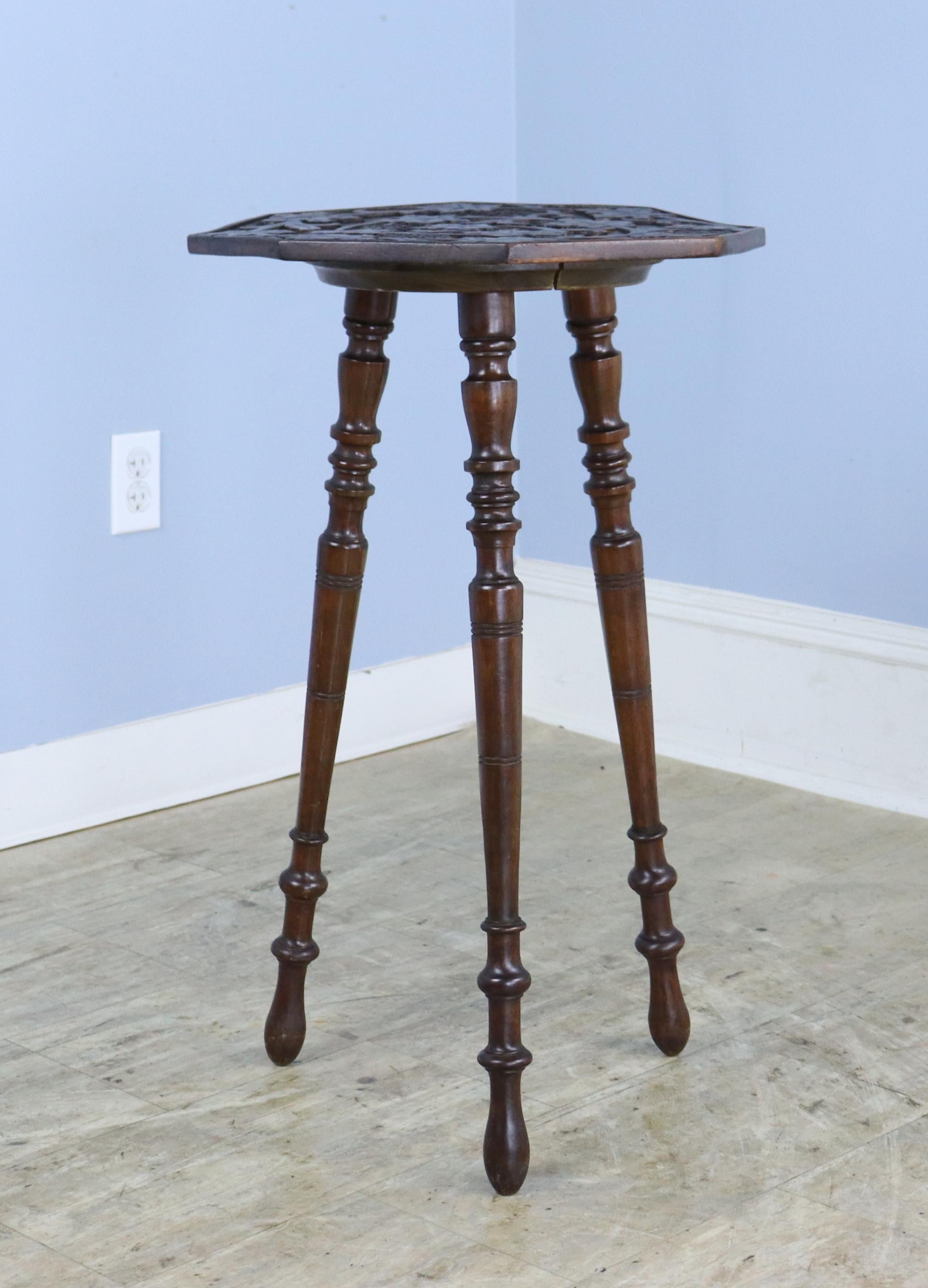 A whisical octagonal cricket, side or lamp table from England's Arts & Crafts period.  The top has a fancifully carved grape and vine motif, and the legs are nicely turned and steady.  no wobbles!