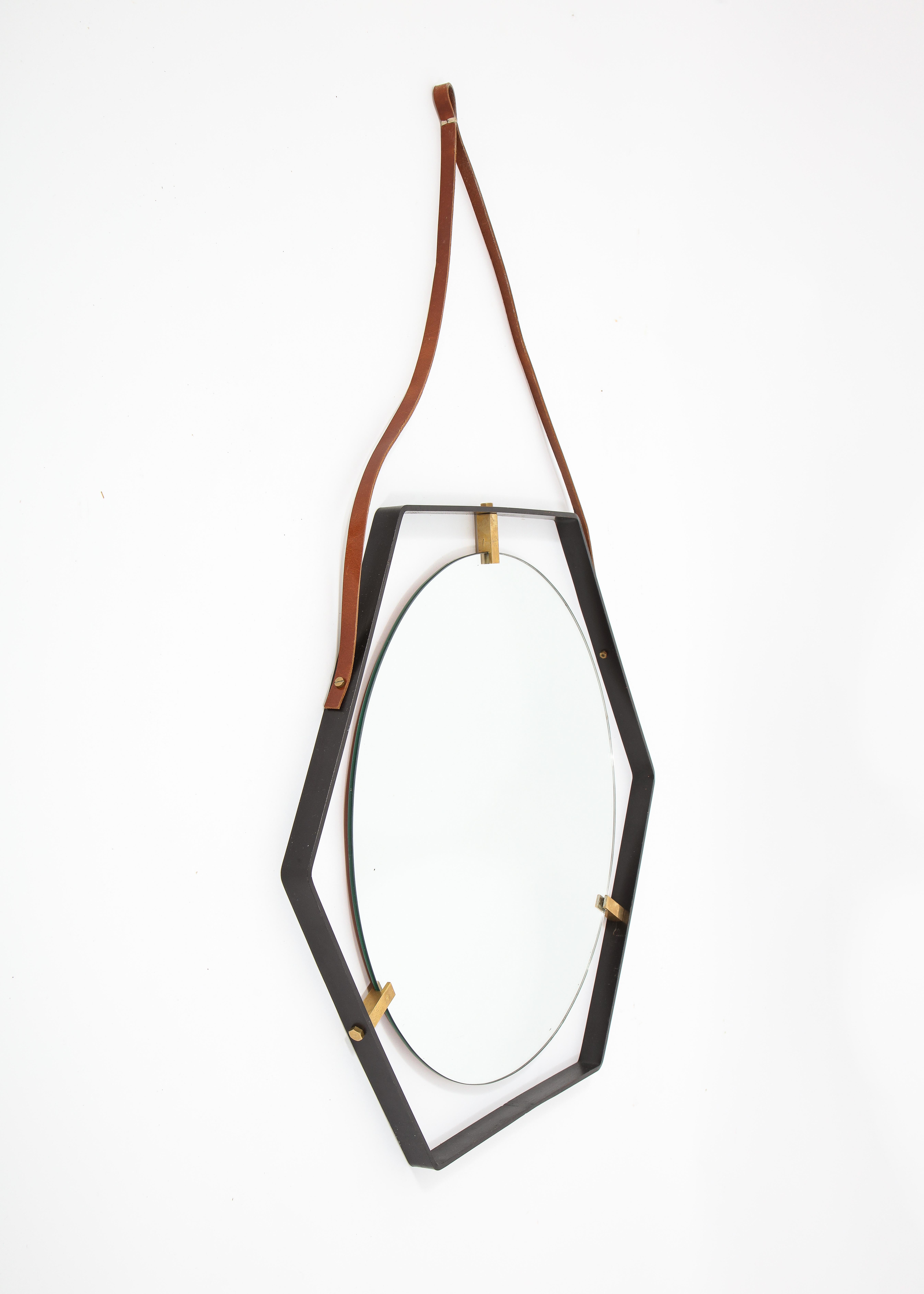 Elegant octagonal mirror with brass supports in a wrought iron frame and hung by a leather belt.