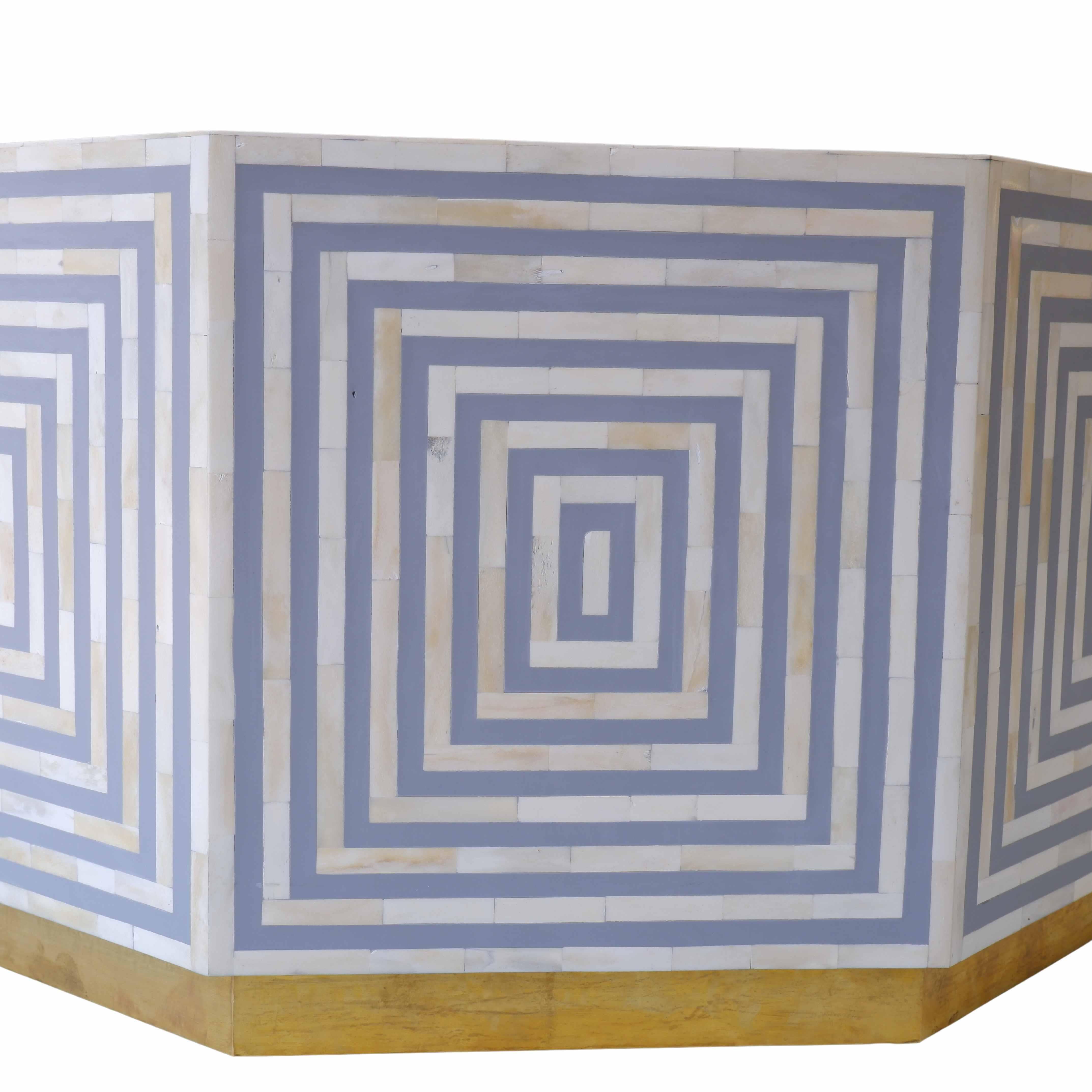 A grey octave coffee table with an eight-face bone inlay line design is a striking piece that seamlessly combines geometric elegance with intricate craftsmanship. The octagonal shape adds a unique twist to the traditional coffee table silhouette,