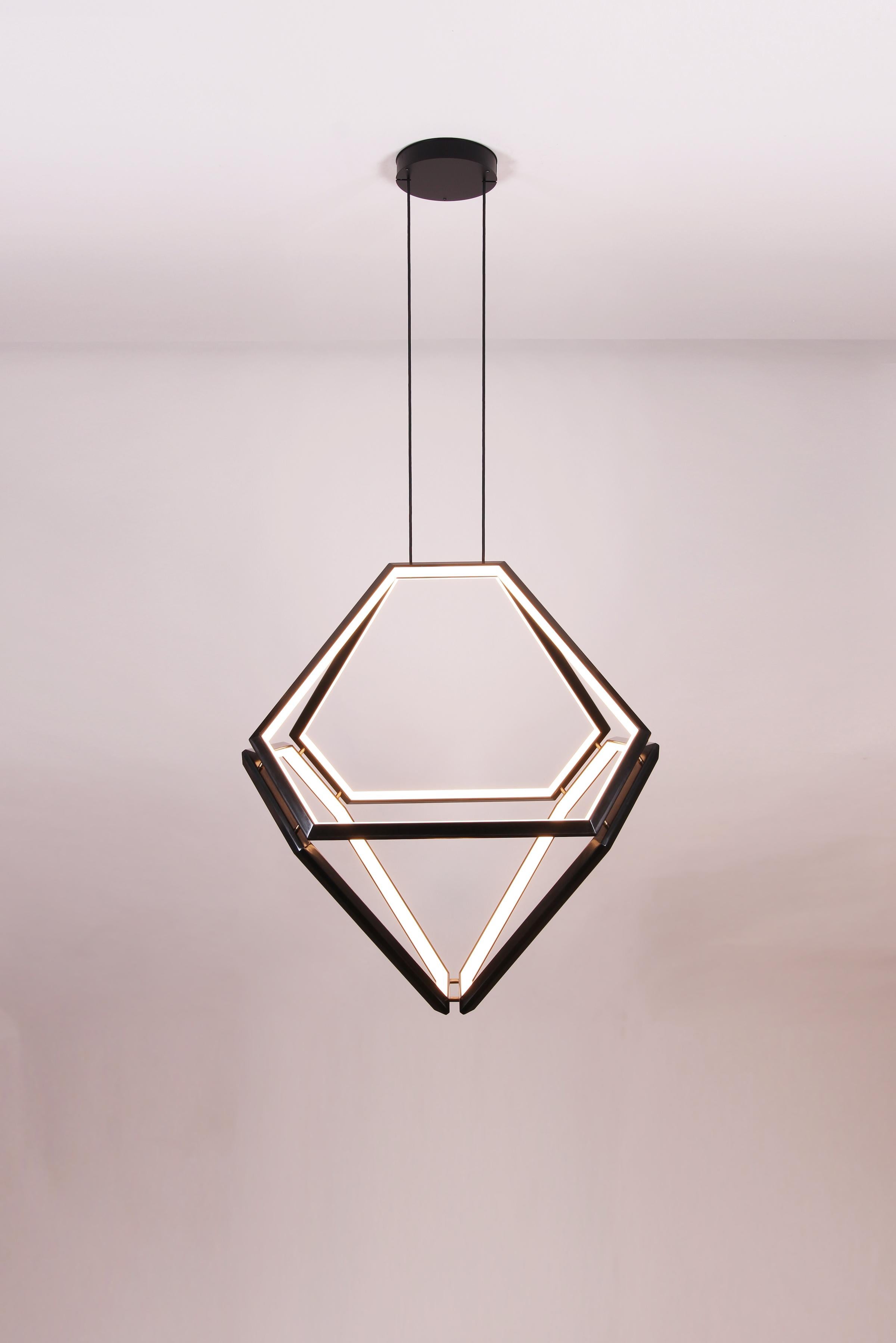 Octo - a One-of-a-kind chandelier created by Studio Endo as a prototype. Limited Edition 1 of 1

Four light fixtures are joined together and wired together to create an octohedron of light. This unique chandelier defines a large space, with a