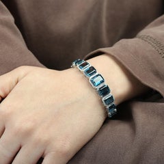 Graduated Octogen Shaped Blue Topaz Oval Bangle With Diamonds In 14k White Gold