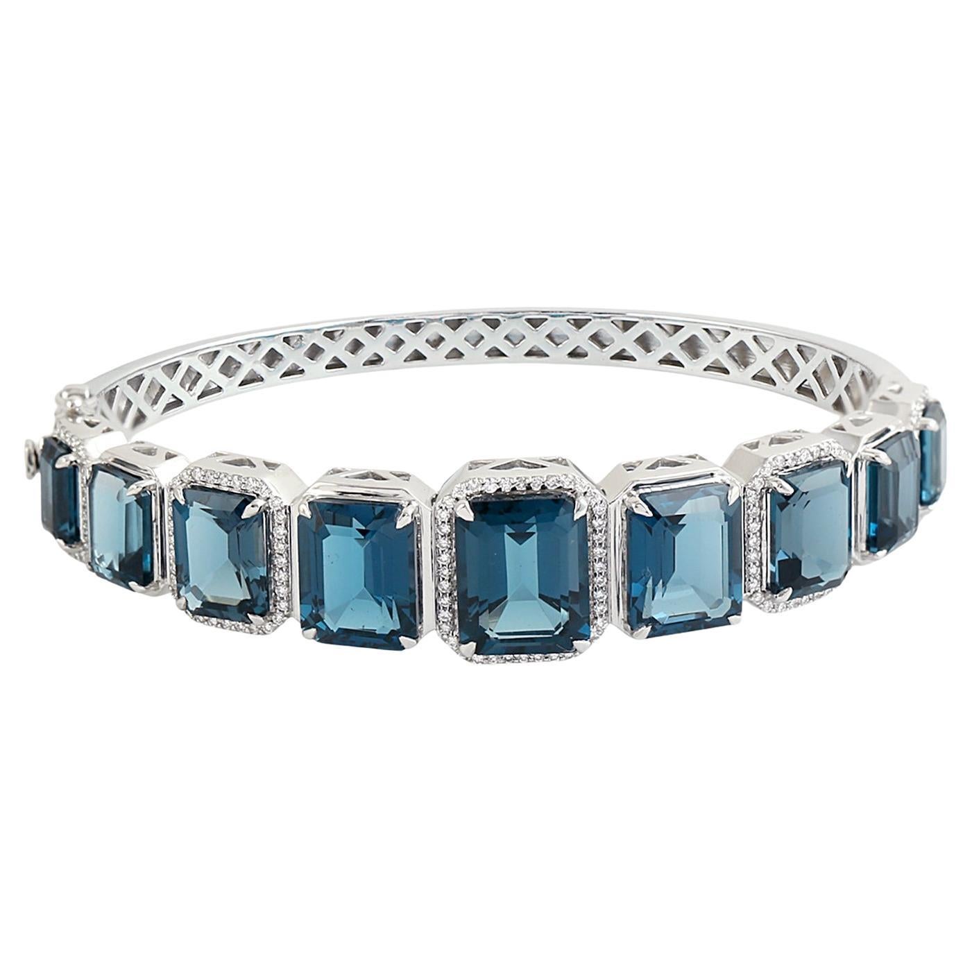 Graduated Octogen Shaped Blue Topaz Oval Bangle With Diamonds In 14k White Gold
