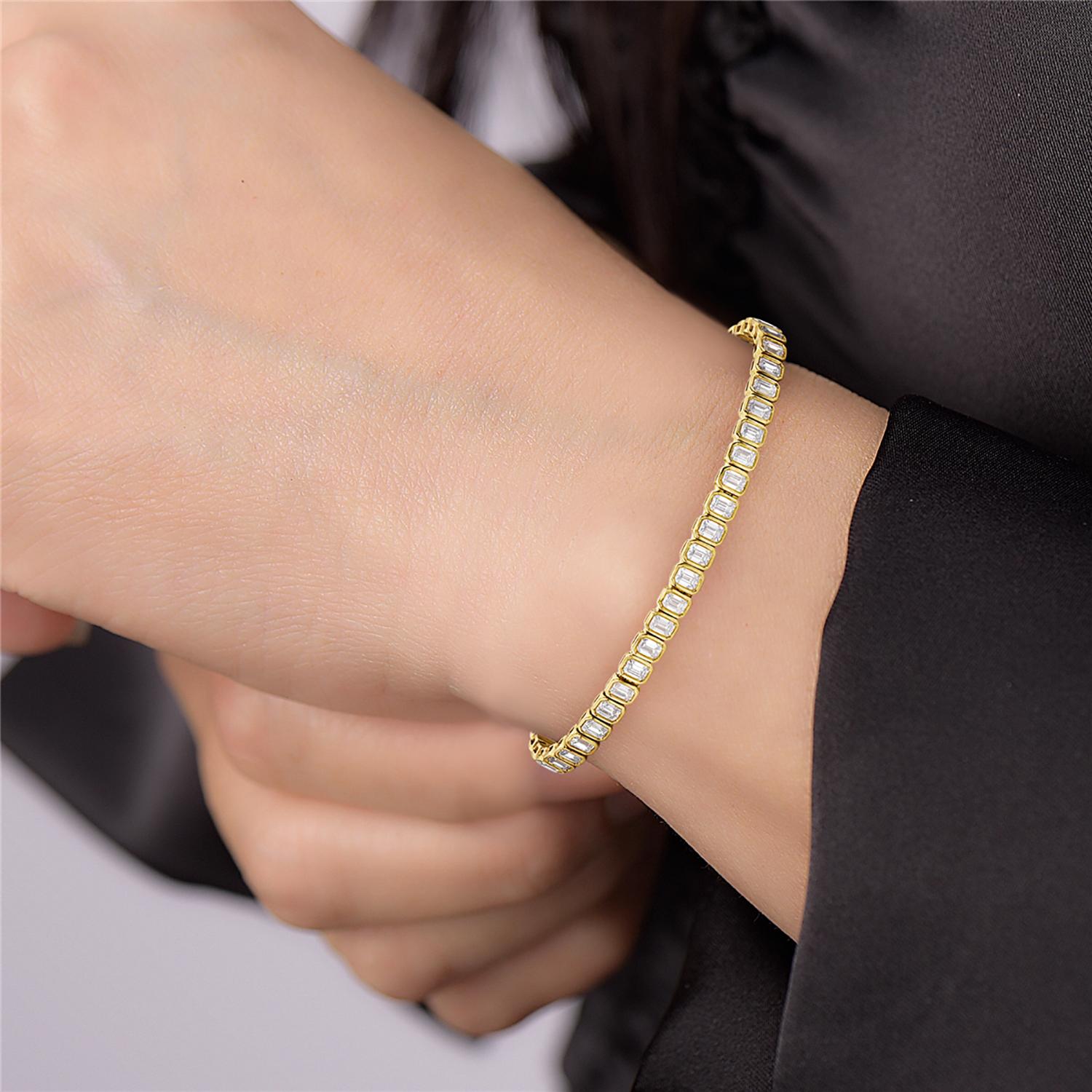 Crafted from high-quality 14k yellow gold, this bracelet features a classic design with a line of octogen-cut diamonds that are expertly set in a continuous row. Each diamond is carefully hand-selected for its exceptional quality and brilliance,