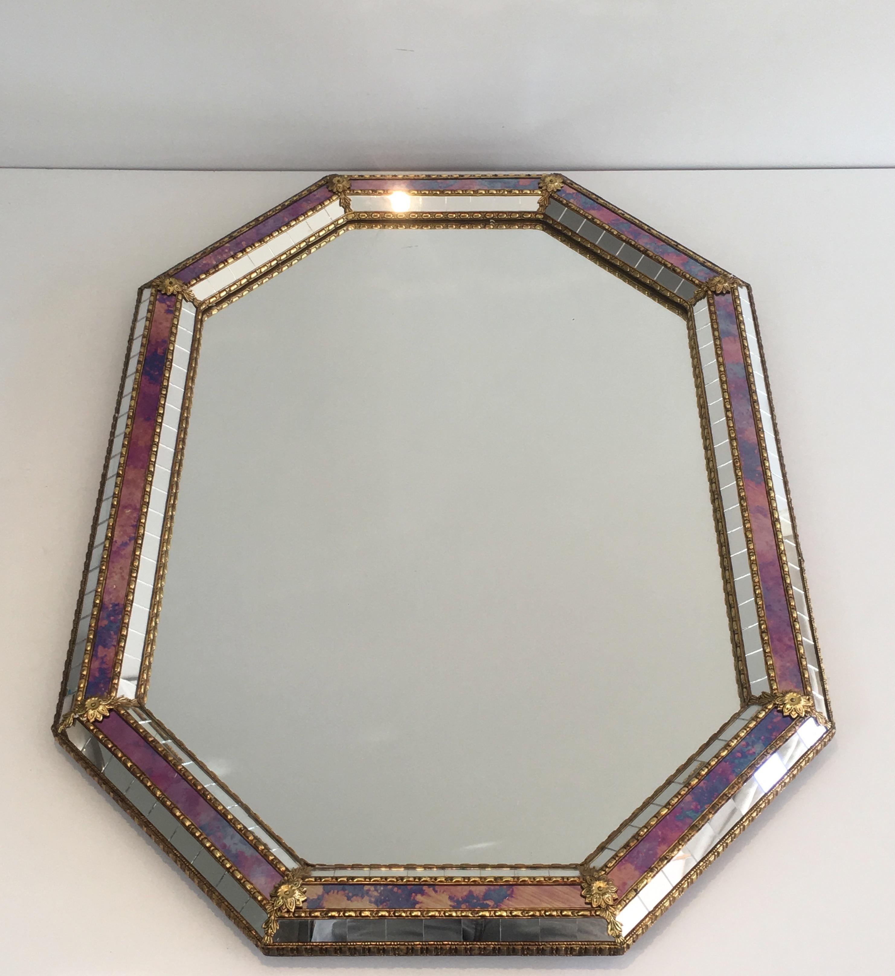 This octogonal mirror is made of brass garlands, flowers and mirror faceted. This is a French work, circa 1970.