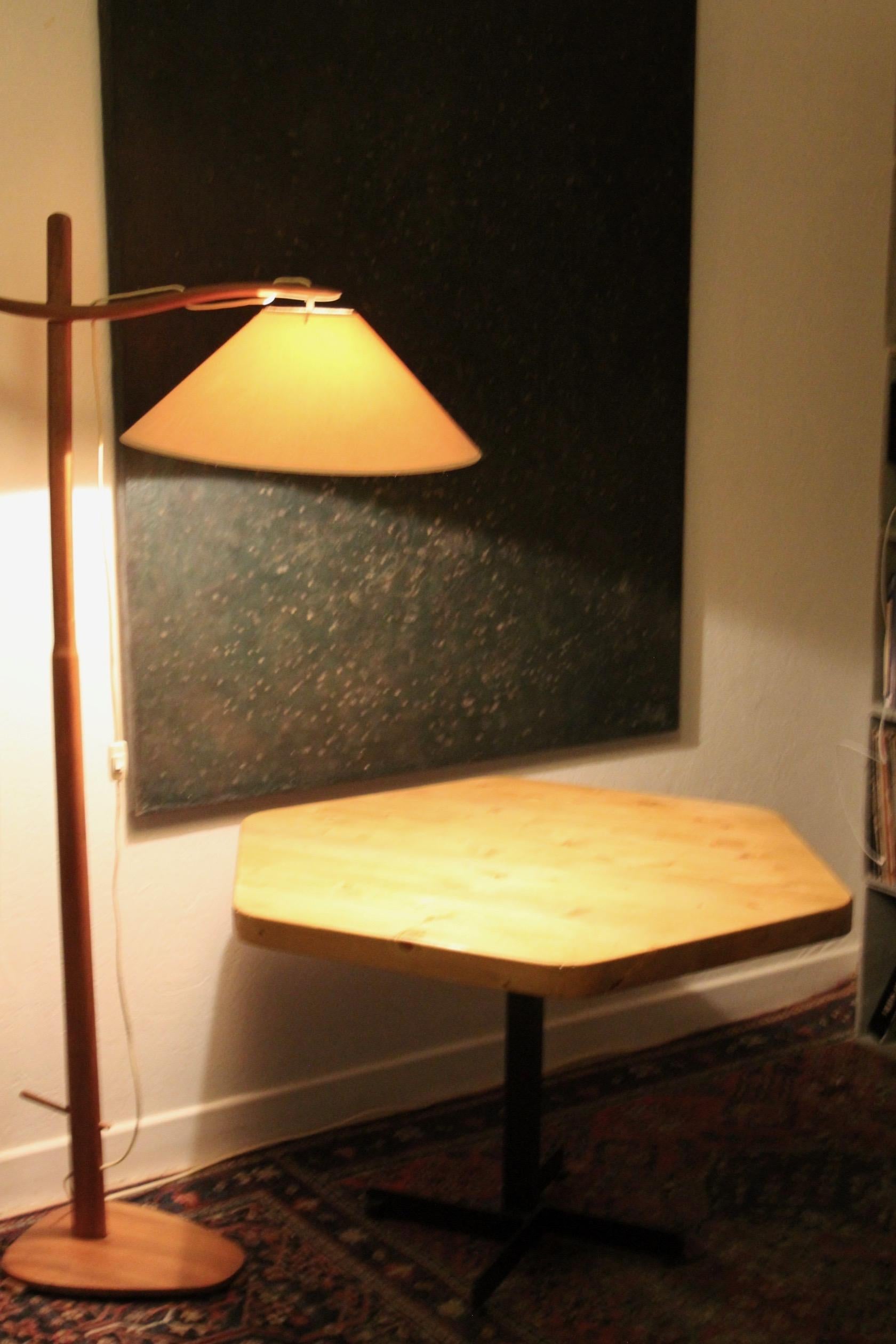 Octogonal table by Charlotte Perriand for Les Arcs ski resort in France, embodying the timeless elegance of Mid-Century Modern dining. This table features a octogonal pine table top gracefully supported by a sophisticated black metal frame. The