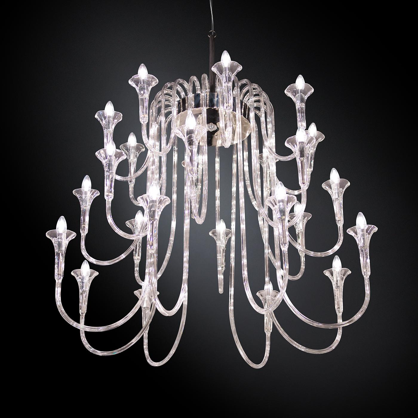 Part of the Octopus collection, this chandelier is a magnificent decorative and functional piece that will capture the eye and the imagination. Its structure comprises a top steel ring from which a cascade of 24 low-thermal-expansion borosilicate