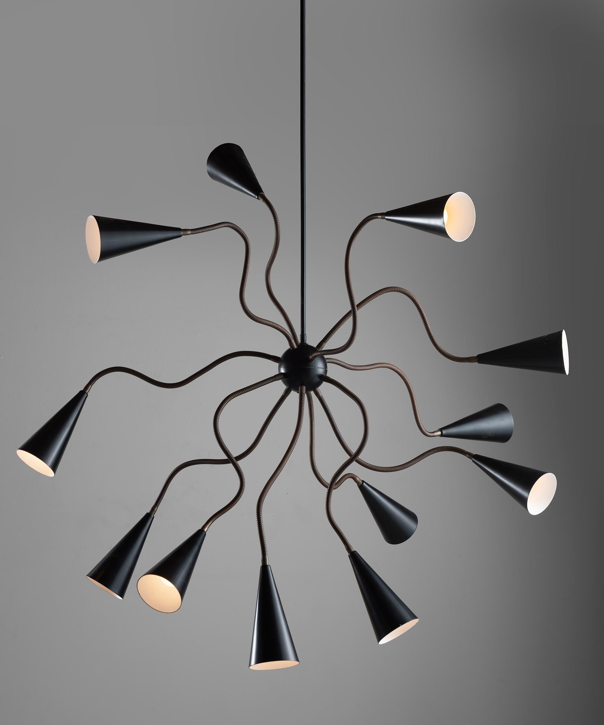 Metamorphic chandelier with 12 articulating brass arms and painted black perforated metal shades.


Measures: 63