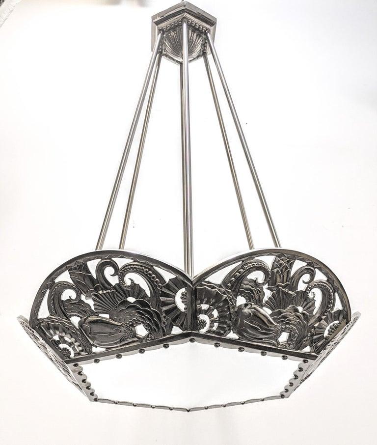 A French Art Deco bronze hexagonal-shaped chandelier with multi-dimensional intertwining geometric flower motif details is called the