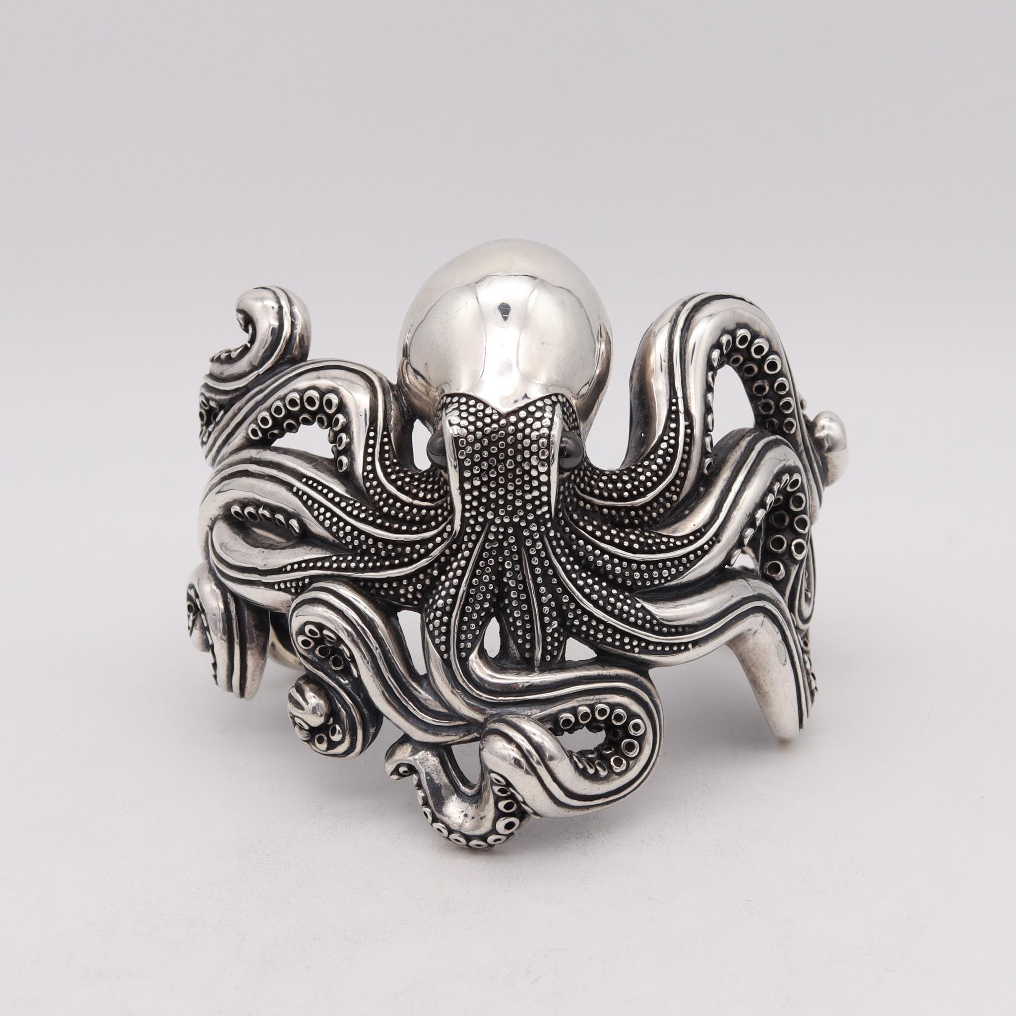 An octopus wrist-arm cuff bracelet.

Fabulous oversized piece, crafted in solid sterling silver .925/.999 in the shape of a big octopus. It was carefully designed with highly textured surfaces and intricate details of the animal. An extremely
