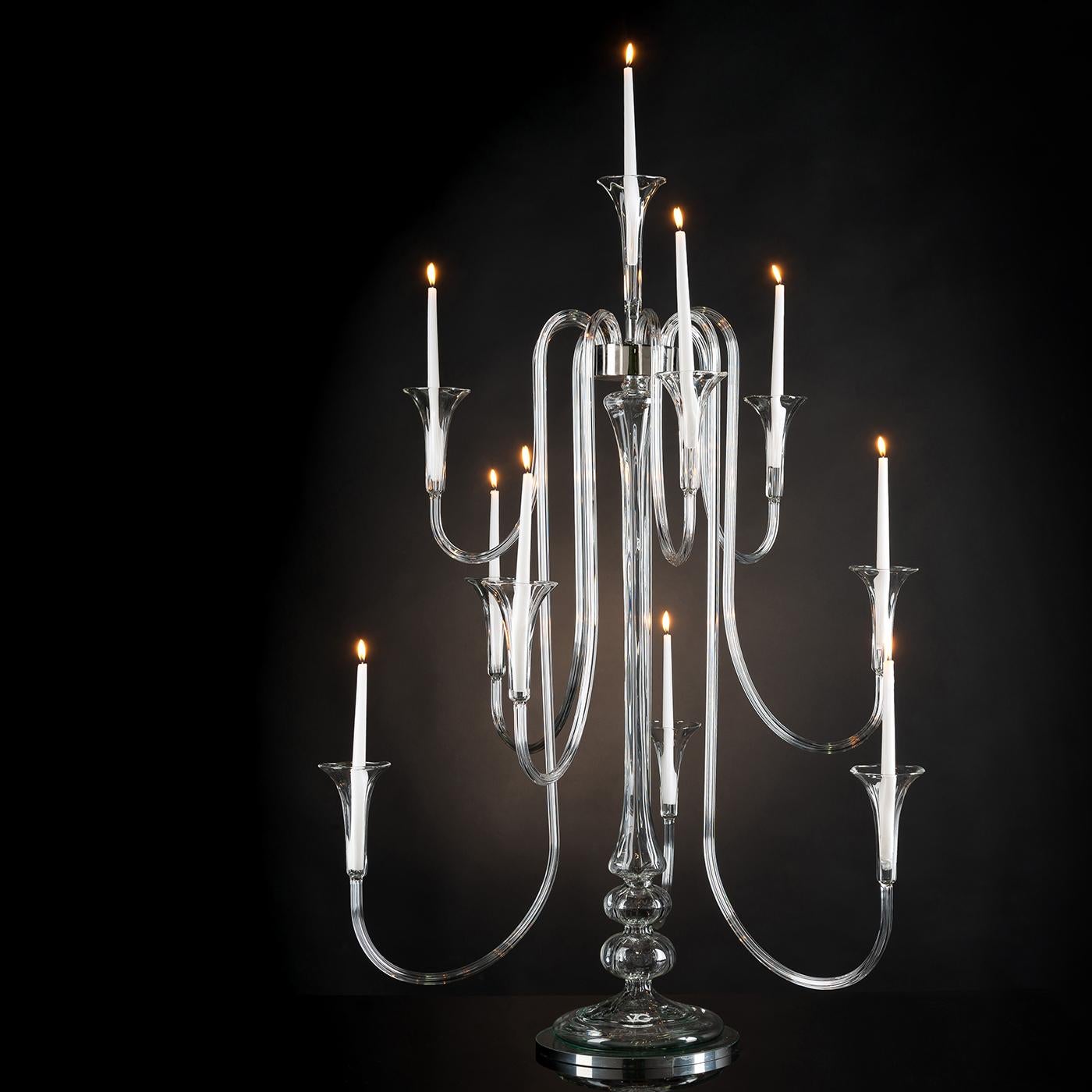 A stunning profile marked by sinuous and dynamic arms, this stunning candelabra will make a refined addition to a modern or eclectic decor. Deftly handcrafted of glass showcasing a natural transparent quality, each arm ends with a flared sconce that