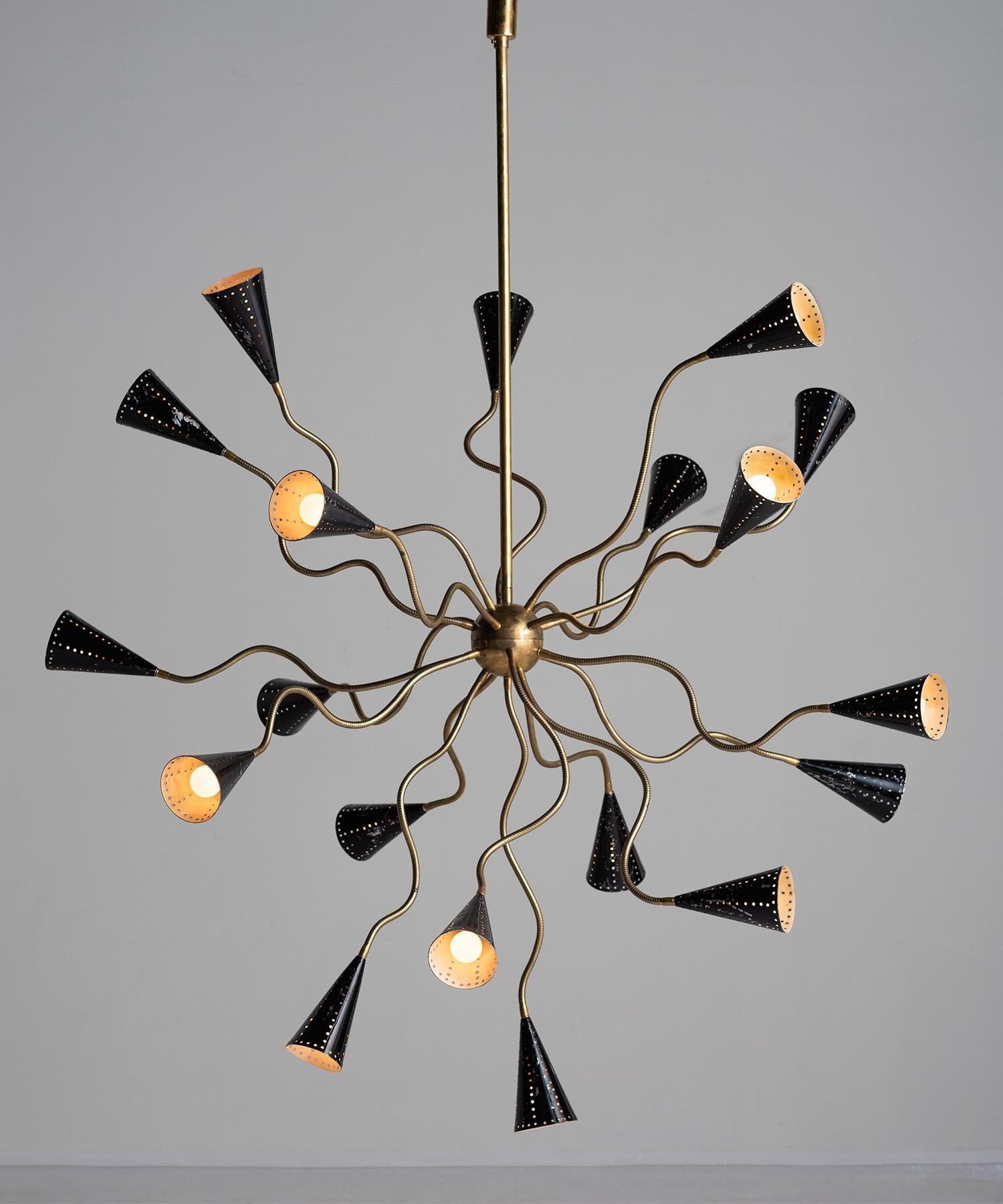 Octopus Sputnik chandelier, Italy, circa 1960.

Metamorphic chandelier with 19 articulating brass arms and painted black perforated metal shades.