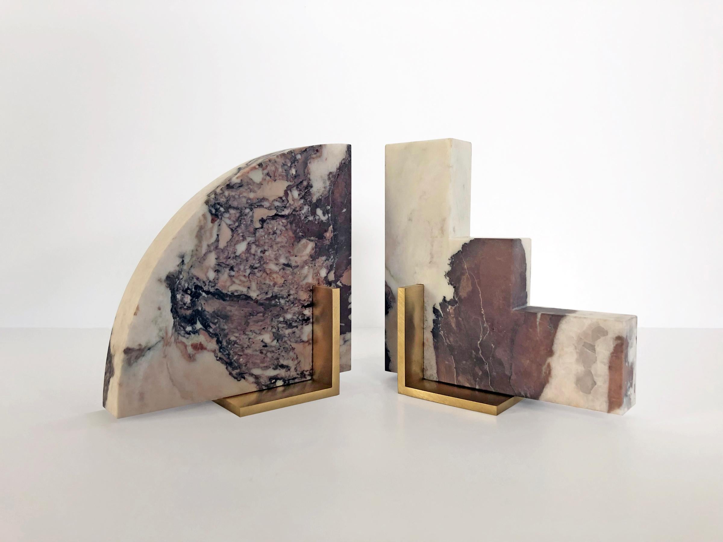 Meet Curvy and Steppy; the two individual bookends which as a pair are known as The Odd Couple Bookends.
Here shown in a honed Calacatta Viola marble with a brushed brass base.
The marble is cut into two geometric shapes and balanced over a brass