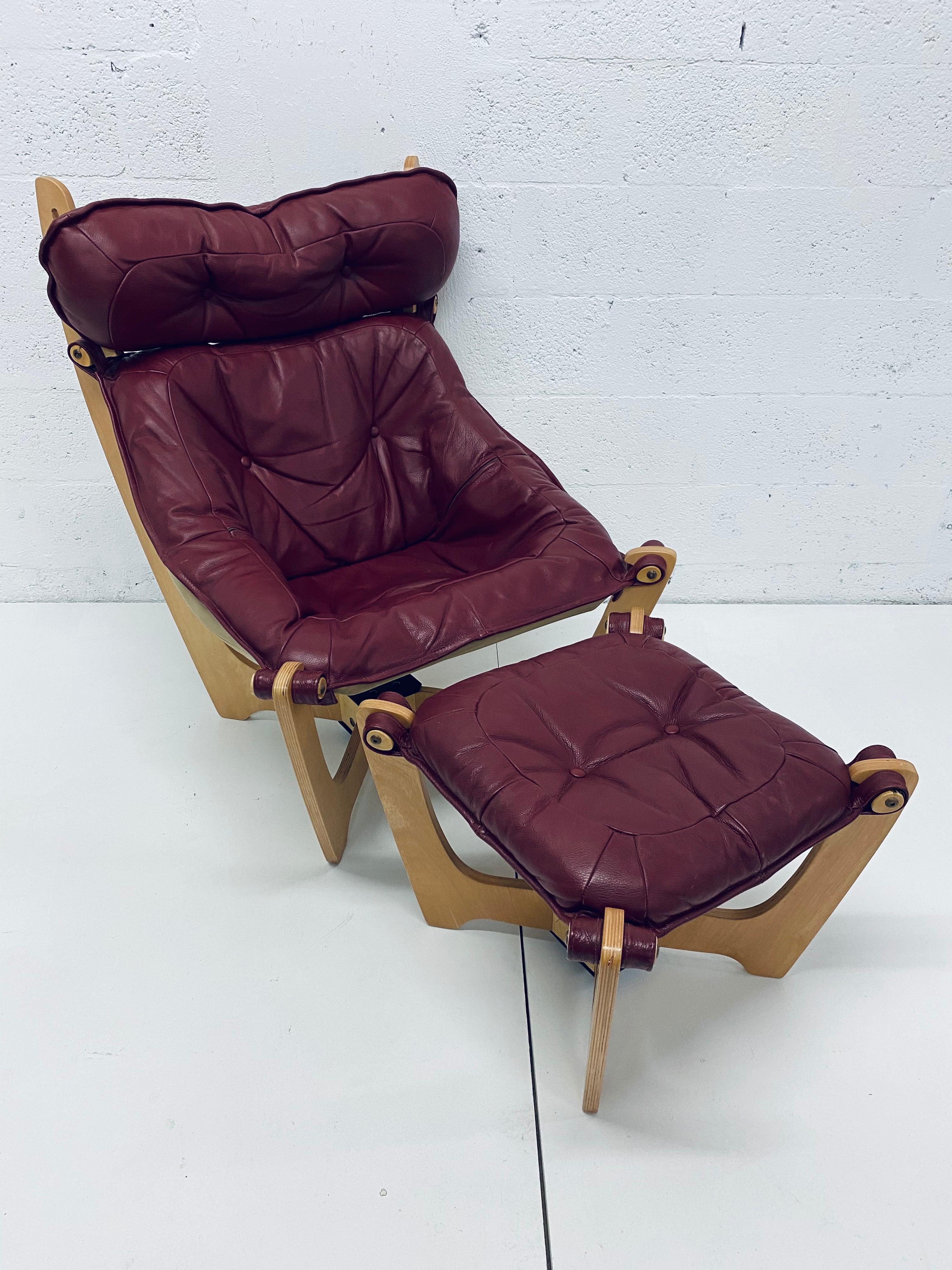 Oxblood leather sling seat suspended from a light blonde stained wood frame with footrest by Odd Knutsen for Hjellegjerde.

Dimensions:
Chair W 29.5