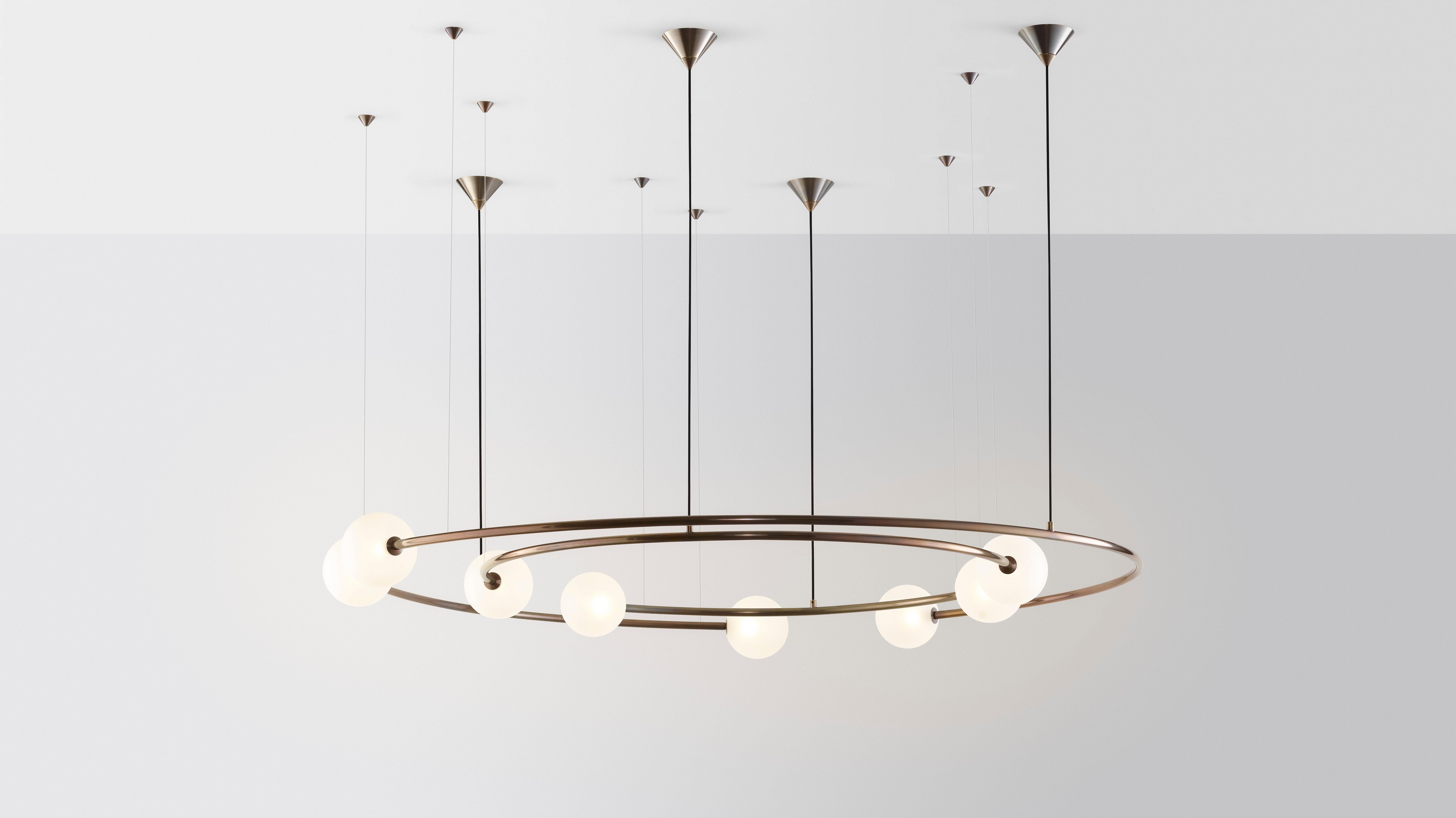 Oddments by Volker Haug 
Dual ring Configuration
Dimensions: W 95 D 160 H 40 cm
Materials: Polished or bronzed brass
Finish: Raw, satin lacquer or enamel
Cord / cable: Black fabric / stainless steel
Suspension: minimum 40 cm

Lamp: G9 - LED or