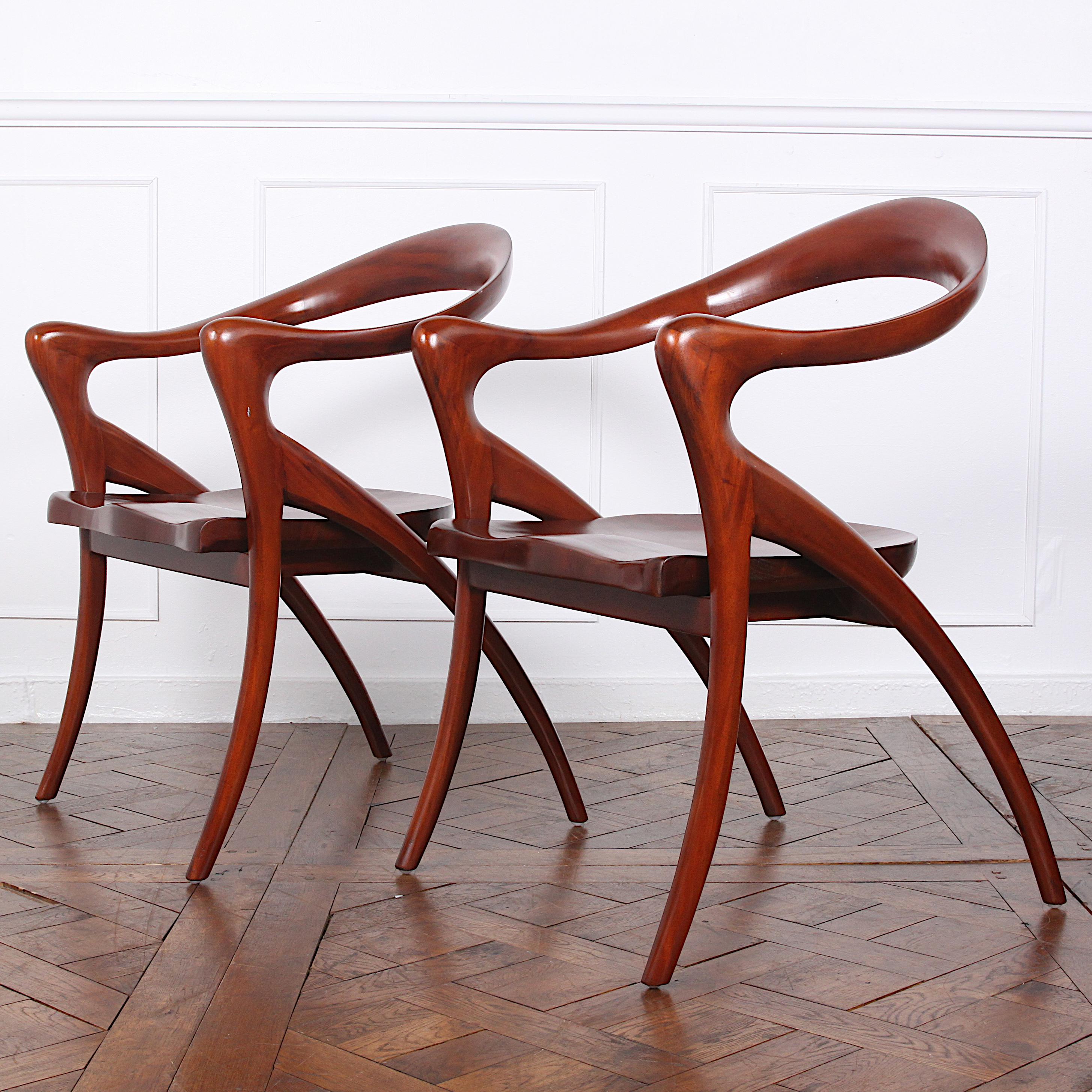 Pair of Grands fauteuils by Olivier de Schrijver (born in 1958). Model “Ode à la femme” with sinuous shaped mahogany armrests and back and with sculpted curved seats.