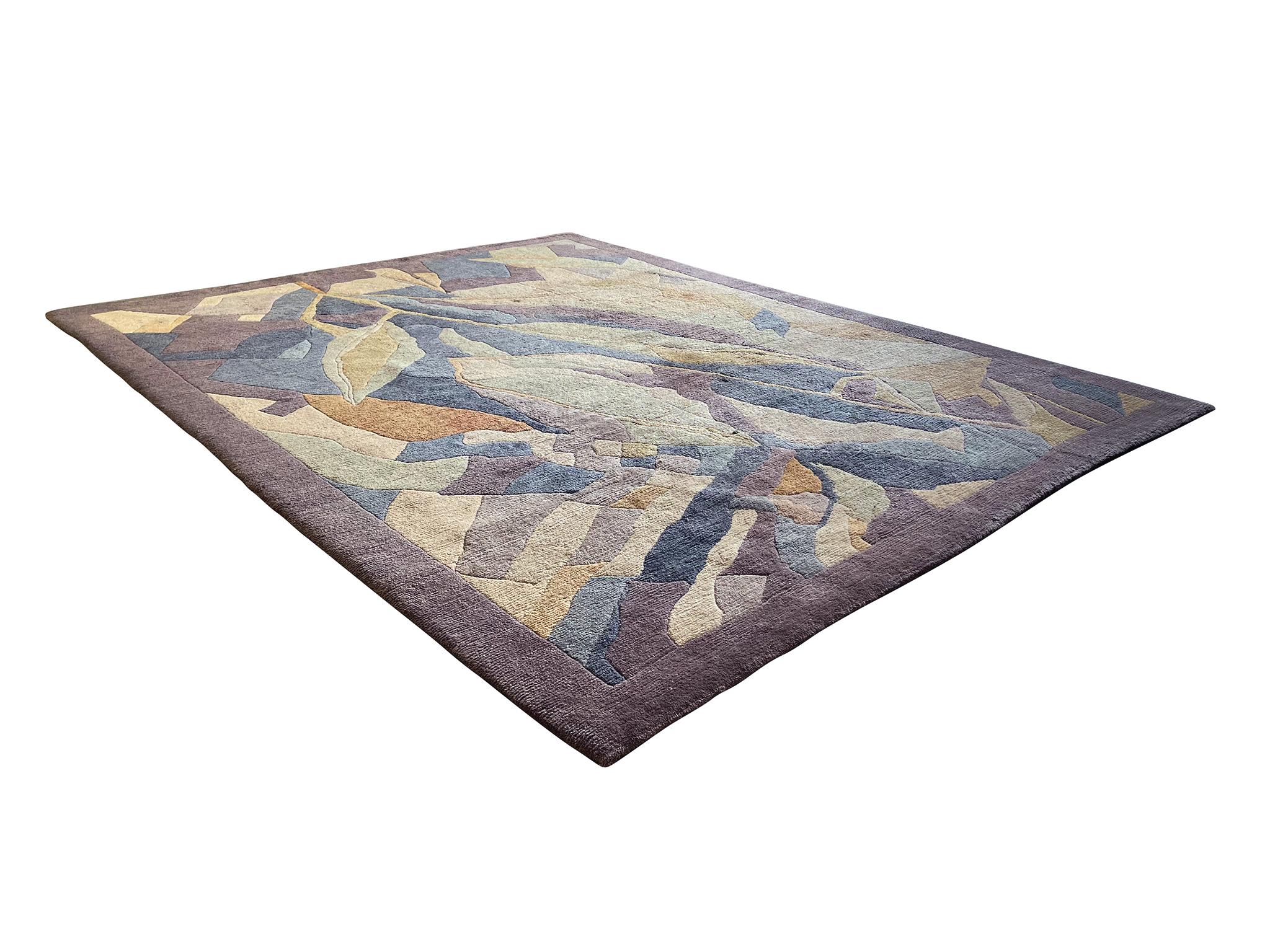 This large, densely patterned carpet was made by Odegard in the late 20th century, with a design attributed to artist Sonia Delaunay. Purples, blues, pale greens, and yellows come together into an abstract floral composition.

Dimensions:
10' 1