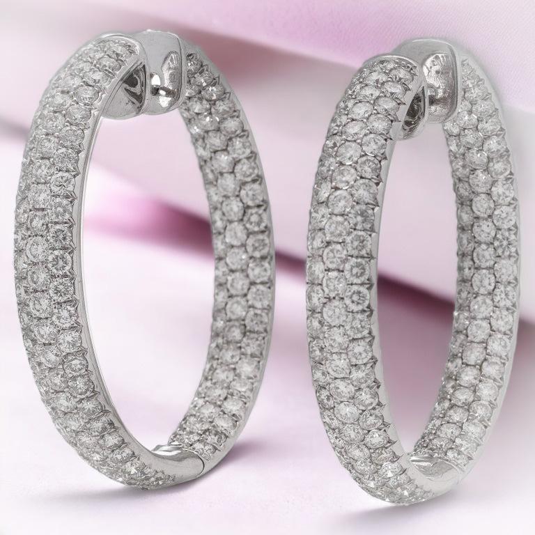 Odelia 18kt. English white gold ladies' pair of double-sided hoop earrings, set with 8.19 carats of round brilliant diamonds. 
Fully hallmarked.
Made in England, 2007 

Dimensions -
Diameter x Depth : 3.75 x 0.65 cm
Total weight: 21 grams

Diamonds