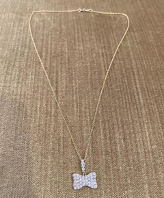 Odelia - Collana con ciondolo a forma di fiocco con pavé di diamanti in oro giallo 18 carati