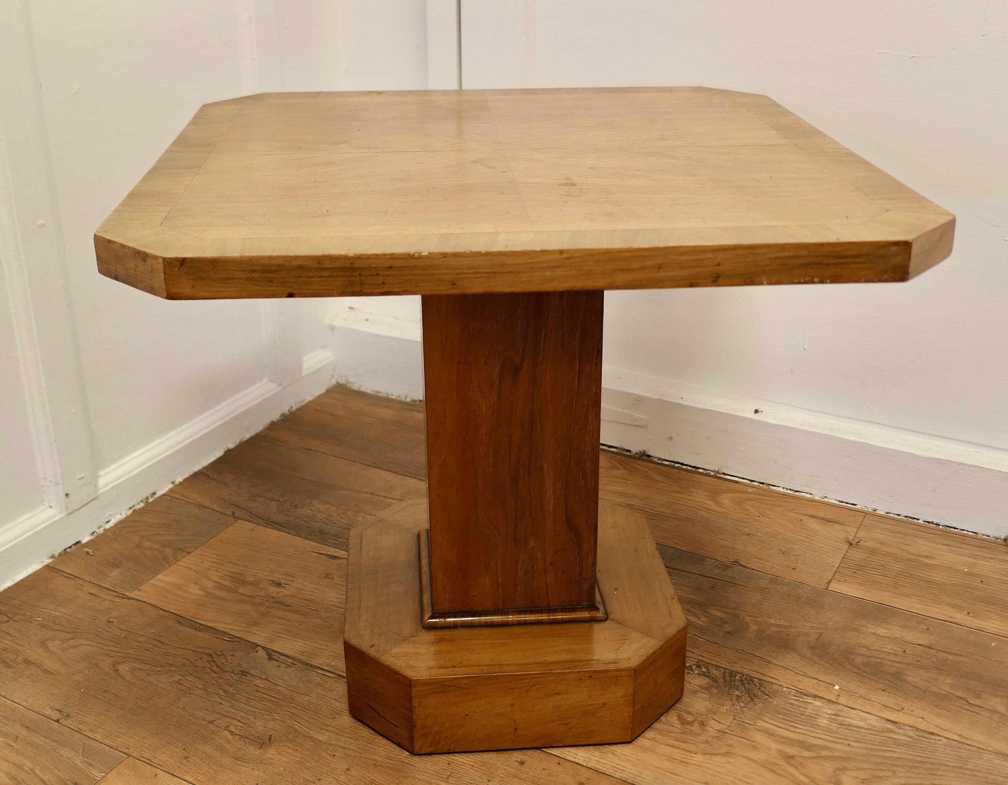 Odeon Style Art Deco Maple Coffee Table

A very stylish piece of Art Deco Design, this 8 sided walnut coffee table is set on an 8 sided plinth and supported on a 4 sided column base
The table is in very good sound used condition 
The Table is