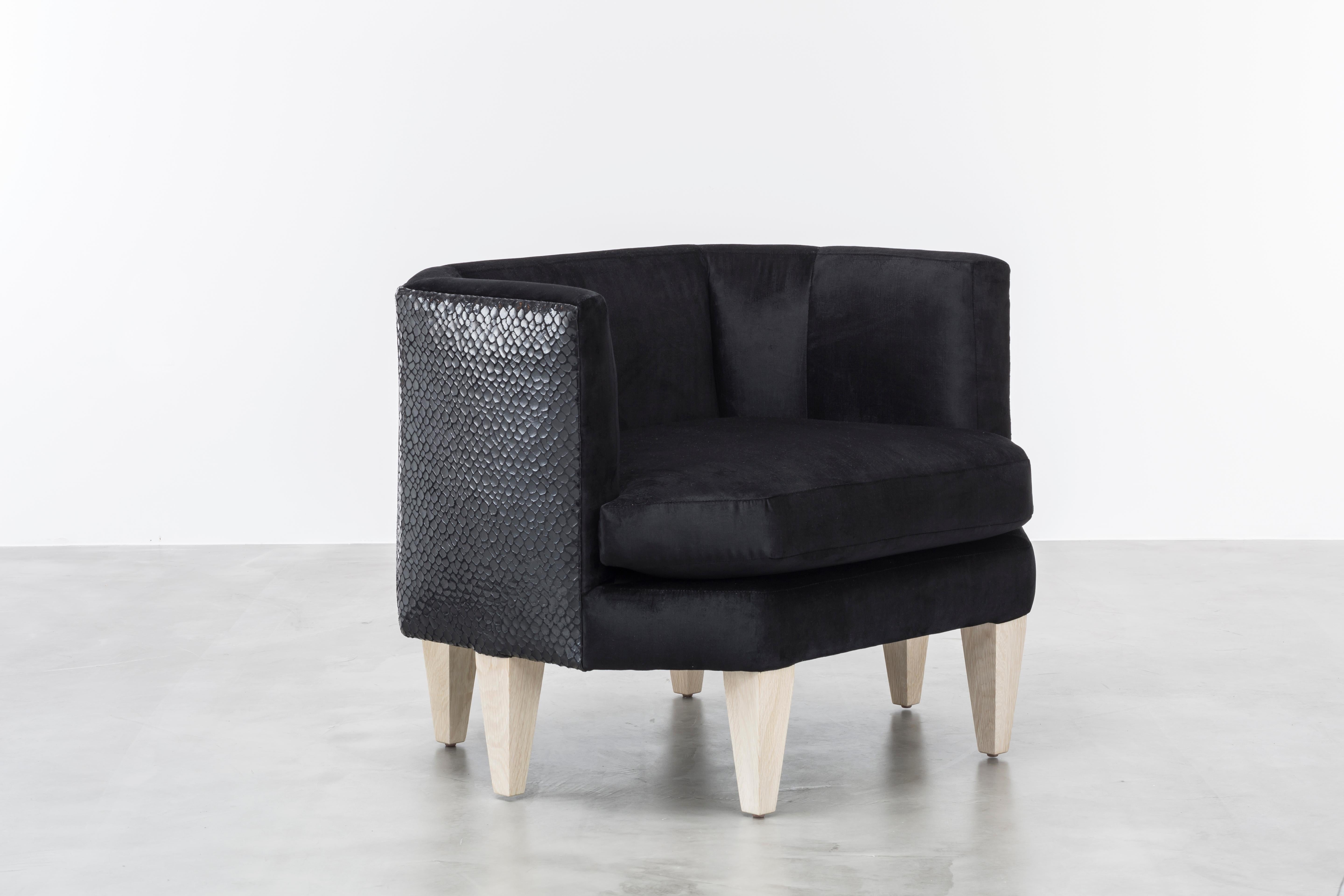 The Odette chair features an octagonal shaped upholstered seat and back with contrast crocodile leather back panels floating upon six wood legs. Fully custom and made to order in California. As shown in Glam Velvet black and contrast crocodile