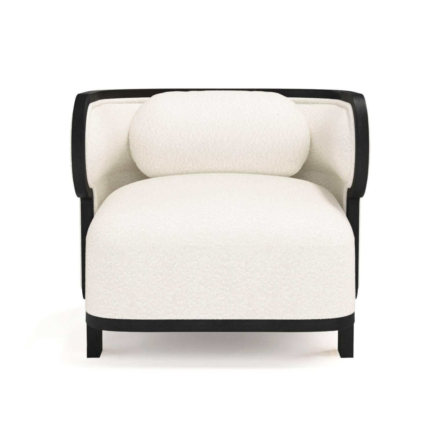 The Odette club chair is a modern take on the cozy wingback armchair that defies all categorizations, being also describable as a Bergère, as well as a barrel chair, thanks to its wooden frame and curved back. Upholstered with brushed Casentino