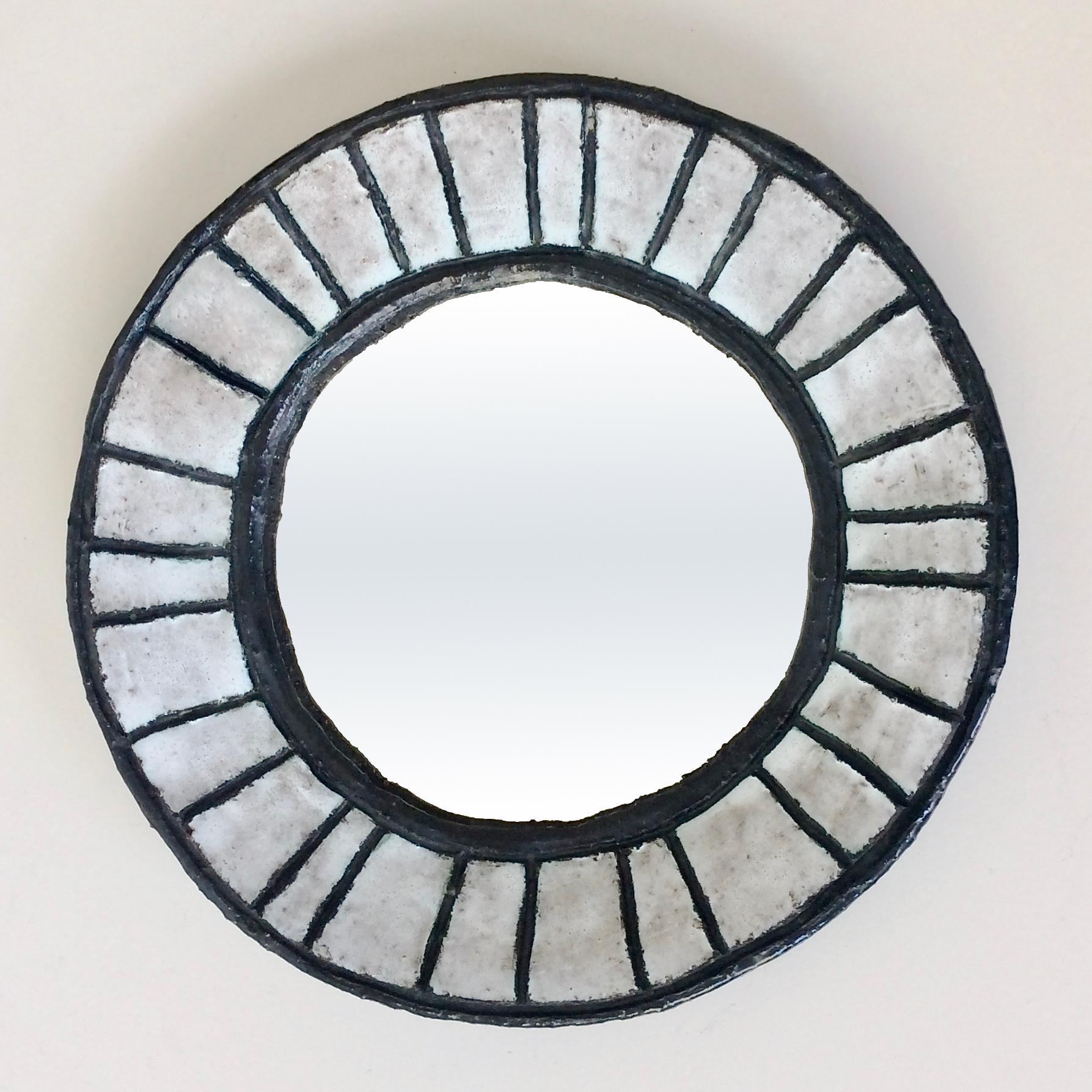 Rare Odette Dijeux circular round mirror, circa 1950, Belgium.
Enameled black and light grey ceramic. 
Signed on the back: Odette Dijeux.
Dimensions: 31 cm diameter, 4 cm D.
Original condition.
Same spirit of works by Georges Jouve, Denise Gatard,