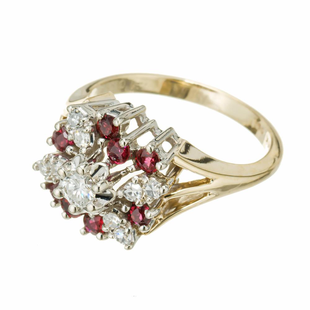 Vintage 1960's ruby and diamond cluster ring. 1 round brilliant cut center diamond with 8 round rubies and 8 sing cut accent diamonds set in a 14k yellow gold cluster cocktail setting with a 14k white gold crown. 

1 round brilliant cut diamonds, H