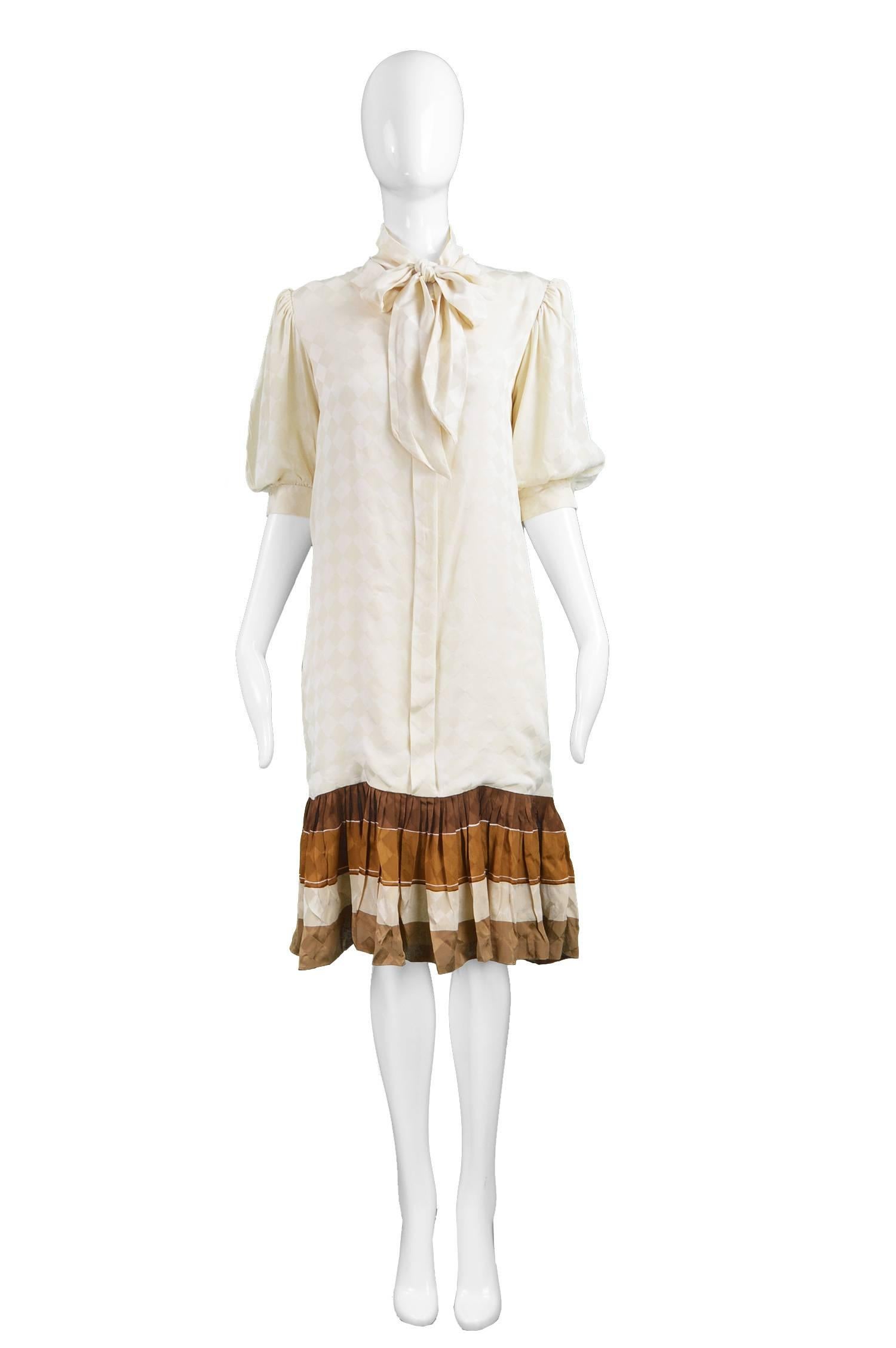 Andrea Odicini Cream & Brown Silk Drop Waist Shift Dress with Pussy Bow, 1980s

Estimated Size: Women's Medium. Please check measurements.  
Bust - 38” / 96cm
Waist - 36”  / 91cm
Hips - 38” / 96cm
Length (Shoulder to Hem) - 40” / 101cm
Shoulder to