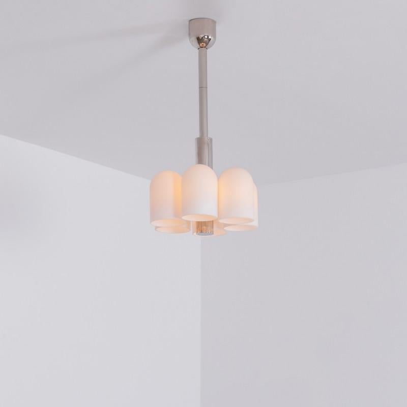 Polished nickel 6 pendant light by Schwung
Dimensions:  D 31.4 x H 59.7 cm
Materials: Polished nickel, frosted glass

Finishes available: Black gunmetal, polished nickel, brass


 Schwung is a German word, and loosely defined, means energy or