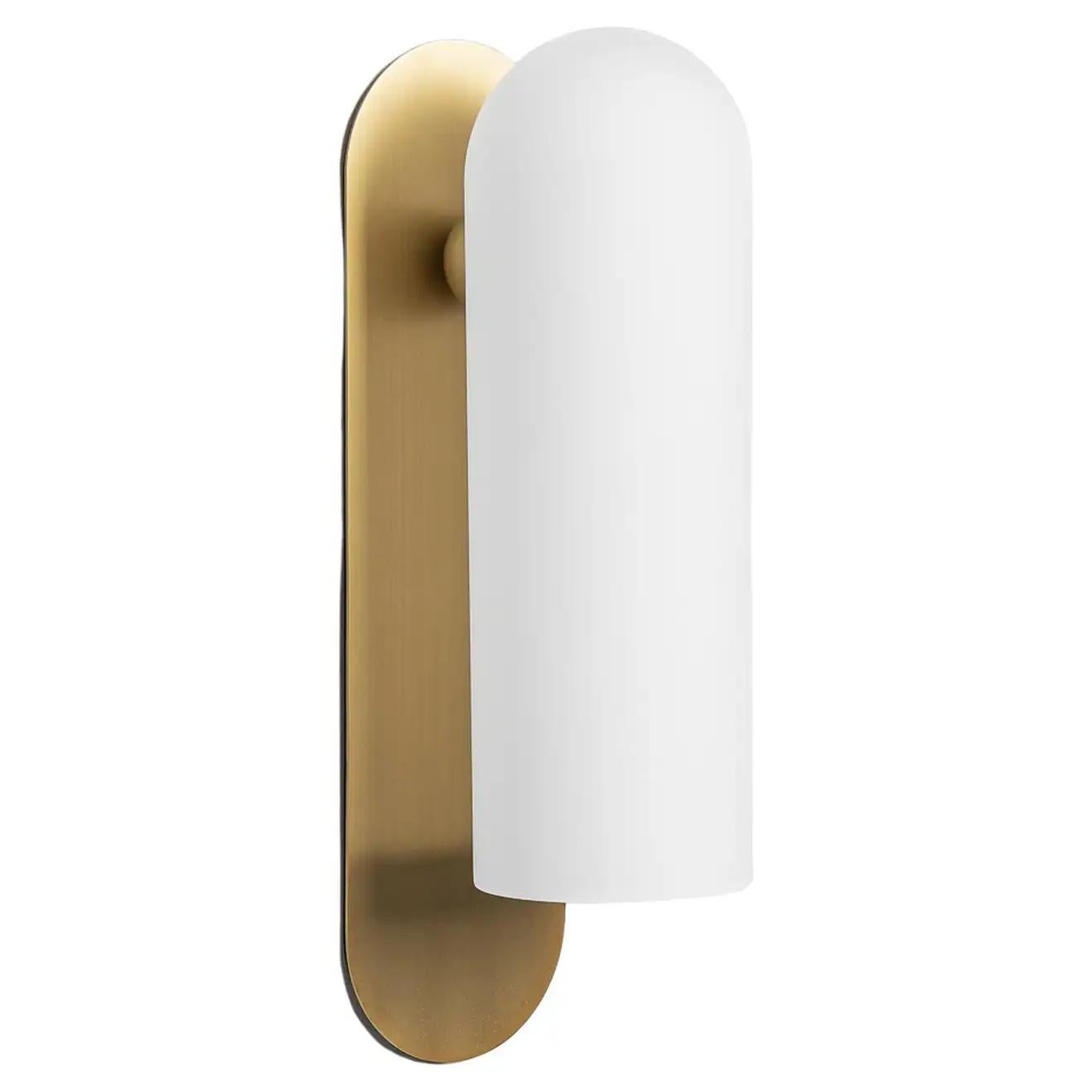 Odyssey LG brass wall sconce by Schwung
Dimensions: W 10.5 x D 14 x H 38 cm
Materials: Brass, frosted glass

Finishes available: Black gunmetal, polished nickel, brass

Schwung is a German word, and loosely defined, means energy or momentumm