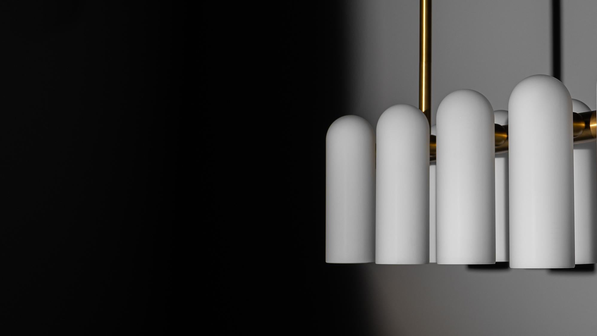 A colonnade of light sources. This delicate engine of frosted glass generates a luminous environment while contrasting brass elements create a sense of stability.

Available in our three signature finishes: Lacquered Burnished Brass (LBB); Black