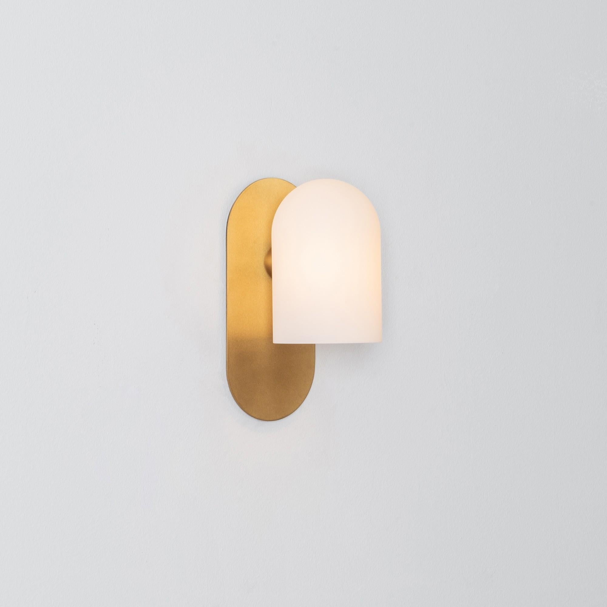 Brass small sconce by Schwung.
Dimensions: W 10.5 x D 14 x H 23 cm.
Materials: brass, frosted glass.

Finishes available: black gunmetal, polished nickel, brass.


Schwung is a German word, and loosely defined, means energy or momentumm of a
