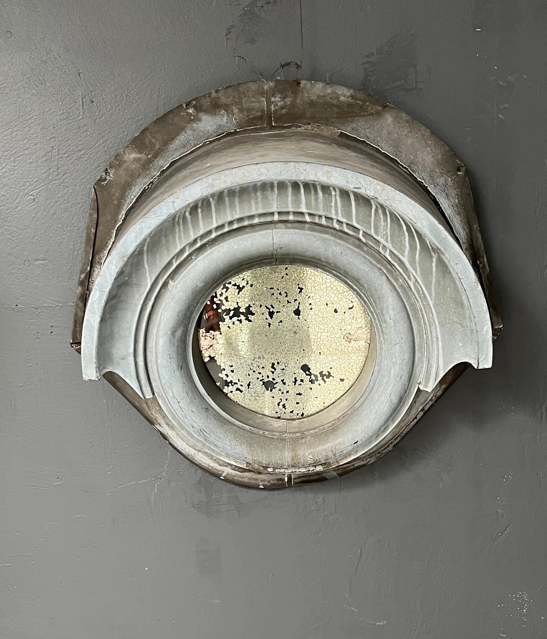 Zinc Oeil-de-Bœuf Mirror Late 19th Century · Parisian Architectural Element

Evoking the spirit of Haussmann-era Paris, this antique œil-de-bœuf mirror features a richly patinated zinc roof window surround repurposed as an architectural frame. The
