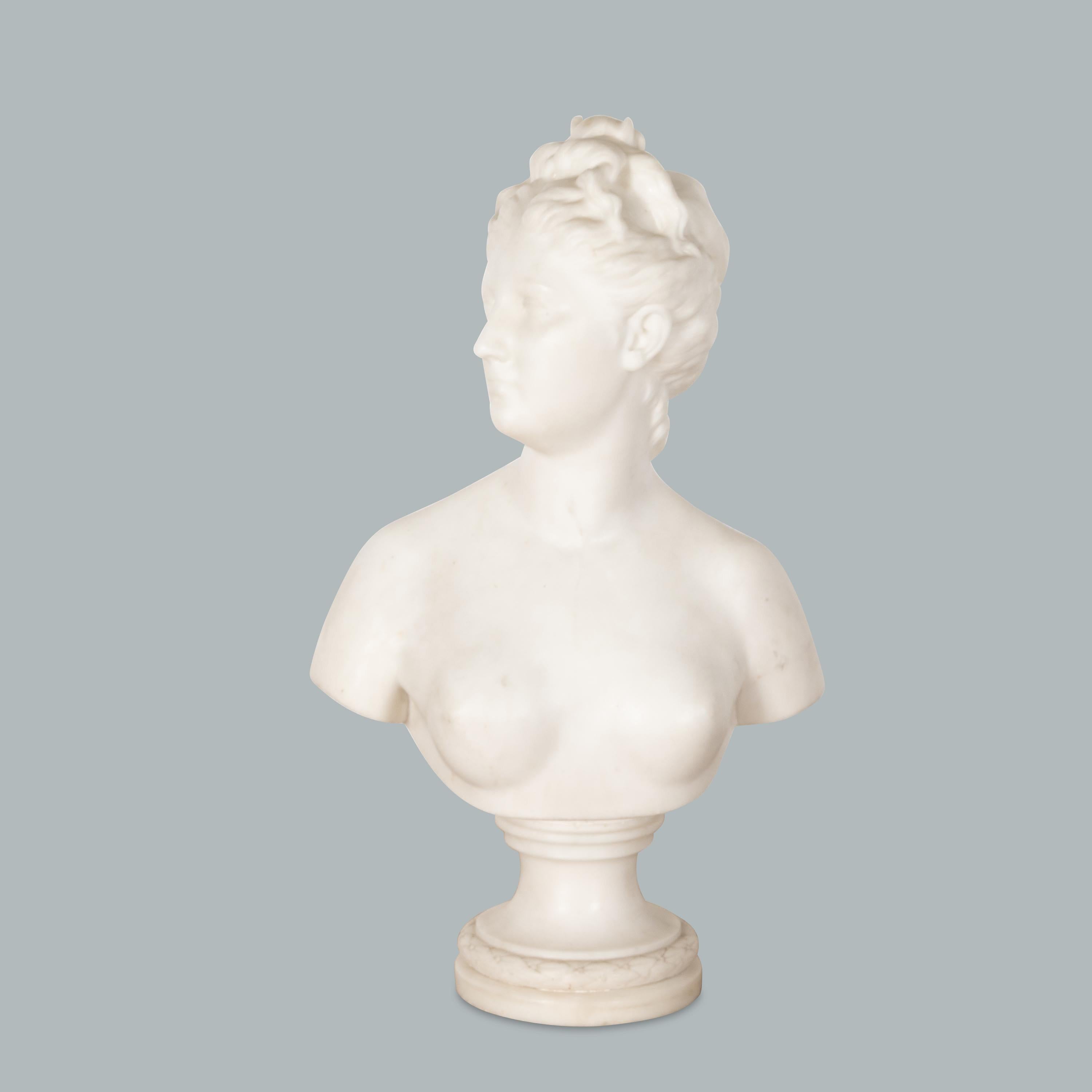 A good quality and finely carved late C18th classical grand Tour marble bust of Diana, with her head turned to dexter and her hair tied up with a fastener in the form of a cresent moon, below showing her bare chest. On a turned socle base with stuff
