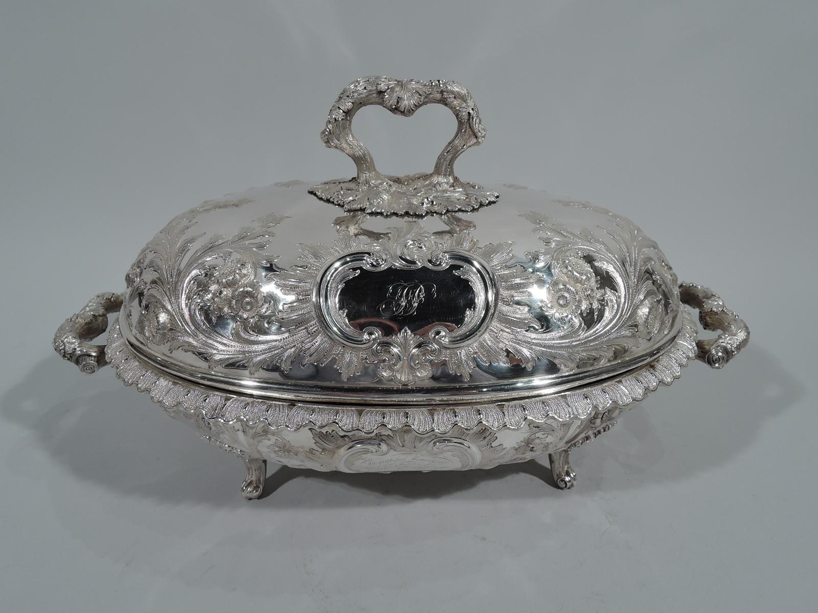 Of presidential interest – Covered sterling silver serving dish. Made by Bailey & Co. in Philadelphia. Ovoid bowl with turned-down and scalloped leaf rim, scrolled leaf-wrapped branch handles, and 4 leaf-mounted volute-scroll supports. Domed cover
