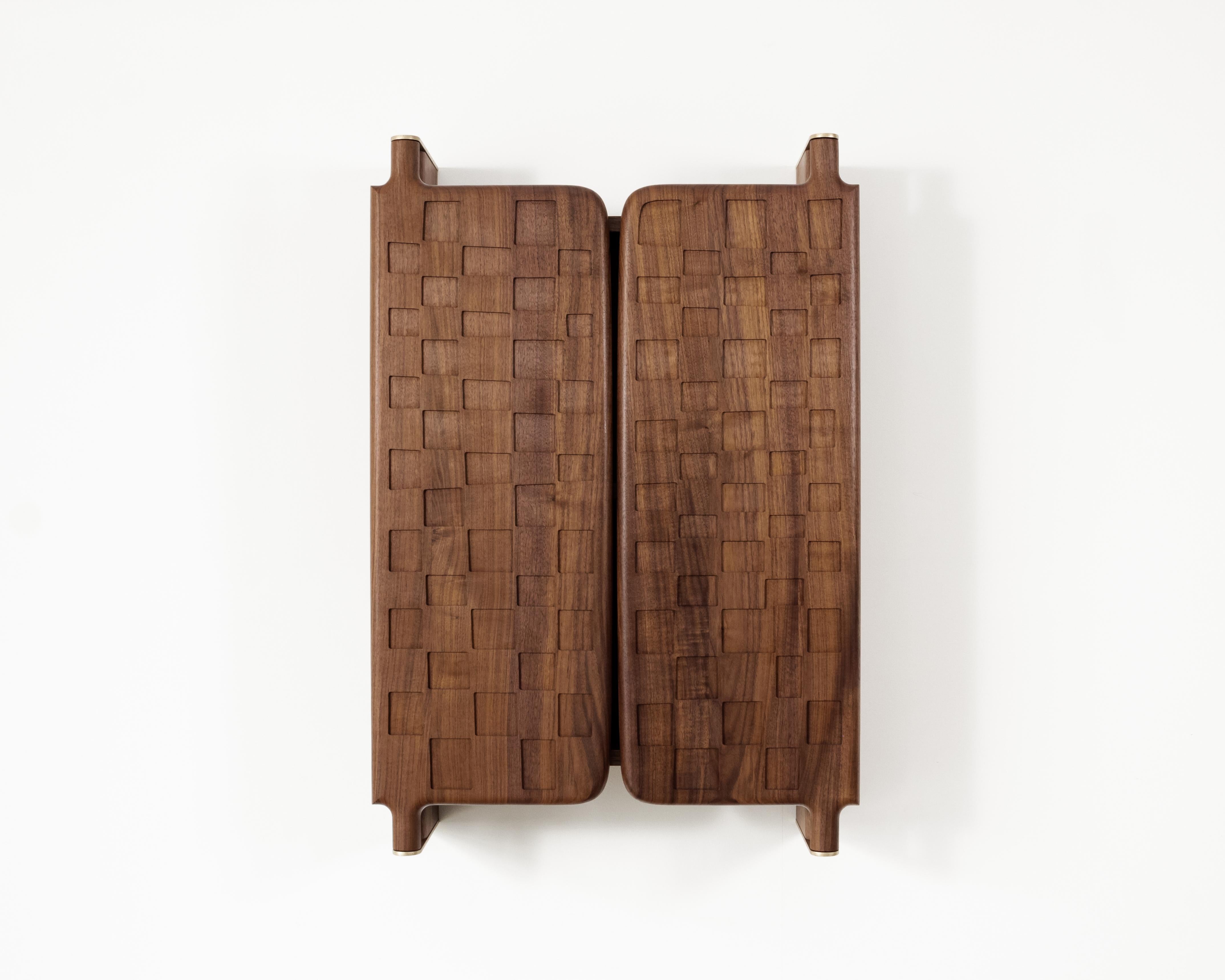 Our Off-Grid Cabinet takes inspiration from the distinctive checkerboard pattern and functional pivot hinge of a Door for an Inner Room made in the late 19th century by an unnamed Baule artist in what is now the Ivory Coast.

With the check pattern